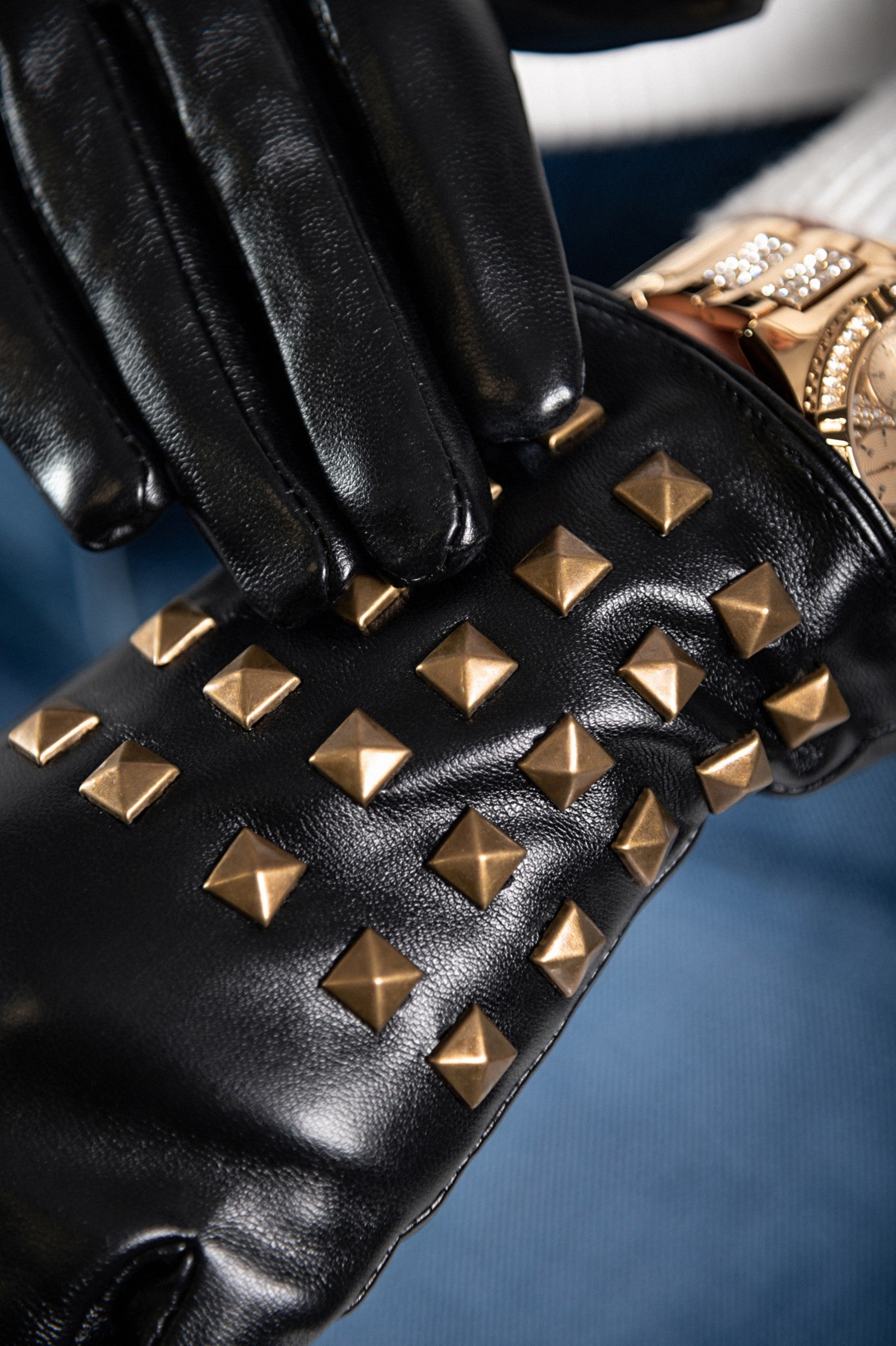 Black imitation leather gloves featuring decorative rivets, showcasing a stylish and warm design.