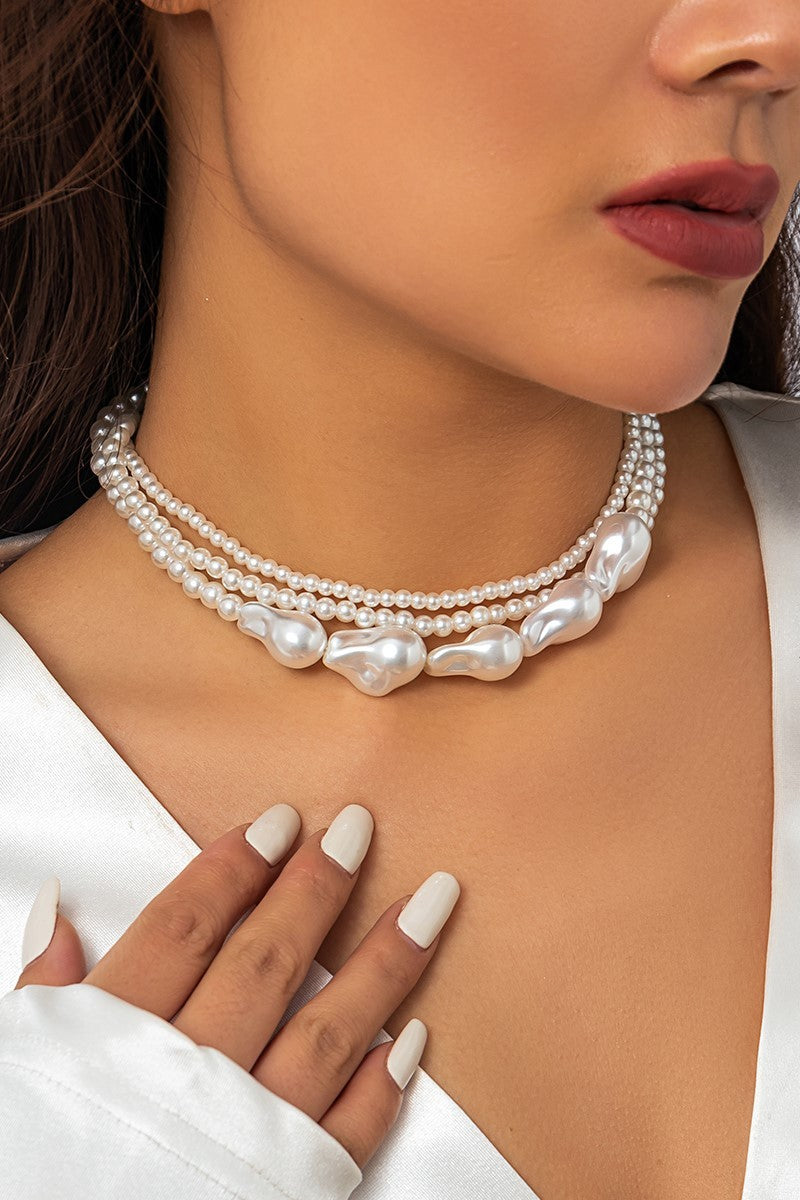 Elegant white imitation pearl necklace with multiple chains and a metal lobster clasp, perfect for any occasion.