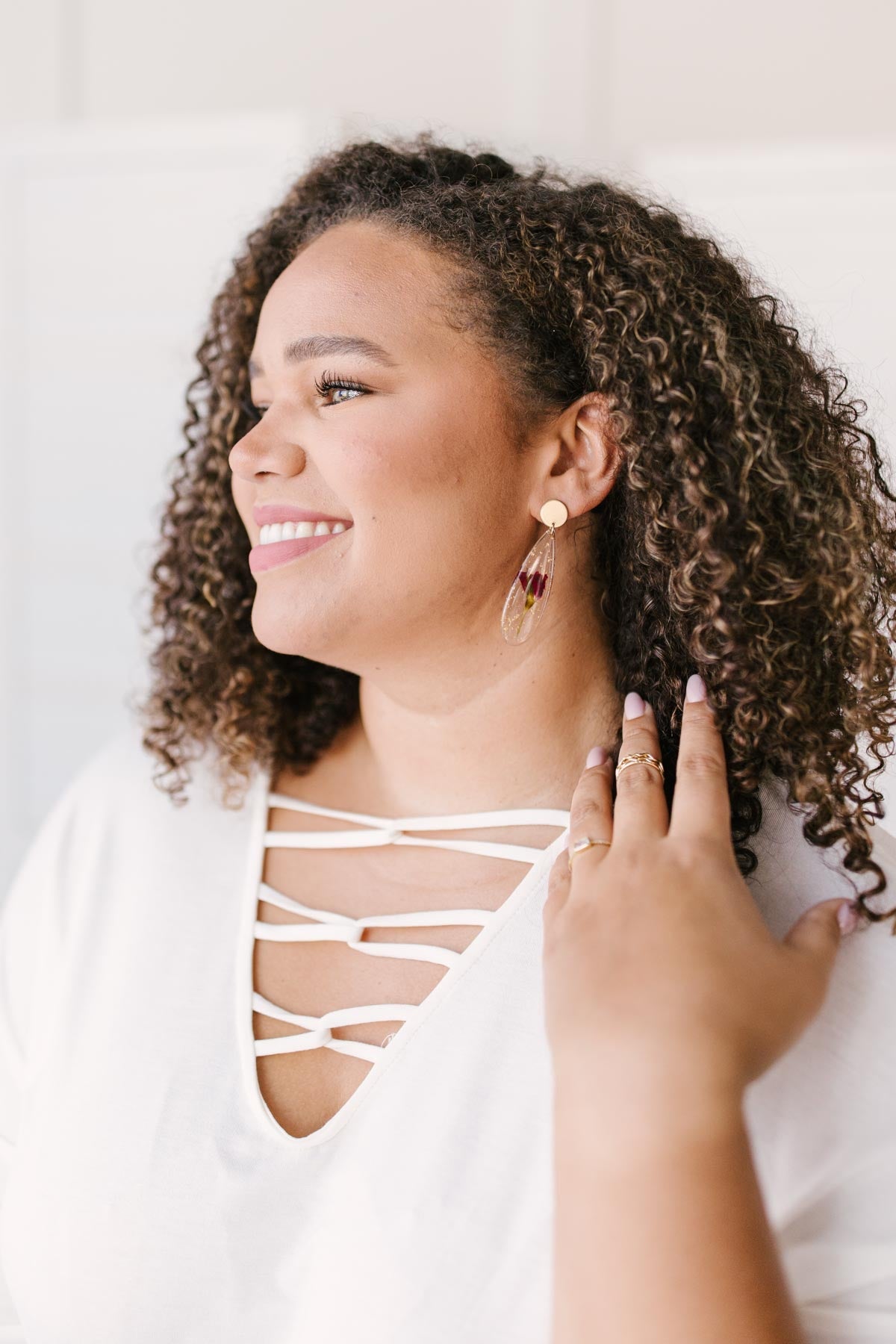 A pair of Impressively Pressed Earrings in Cardinal featuring unique floral designs encased in translucent tear drop shapes.