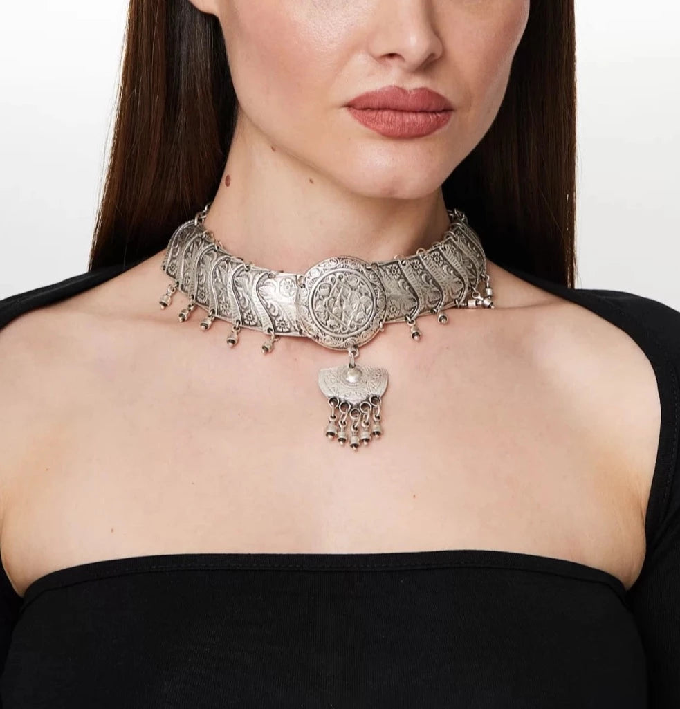 A unique silver plated antique choker necklace with tribal designs, showcasing its intricate craftsmanship and adjustable feature.