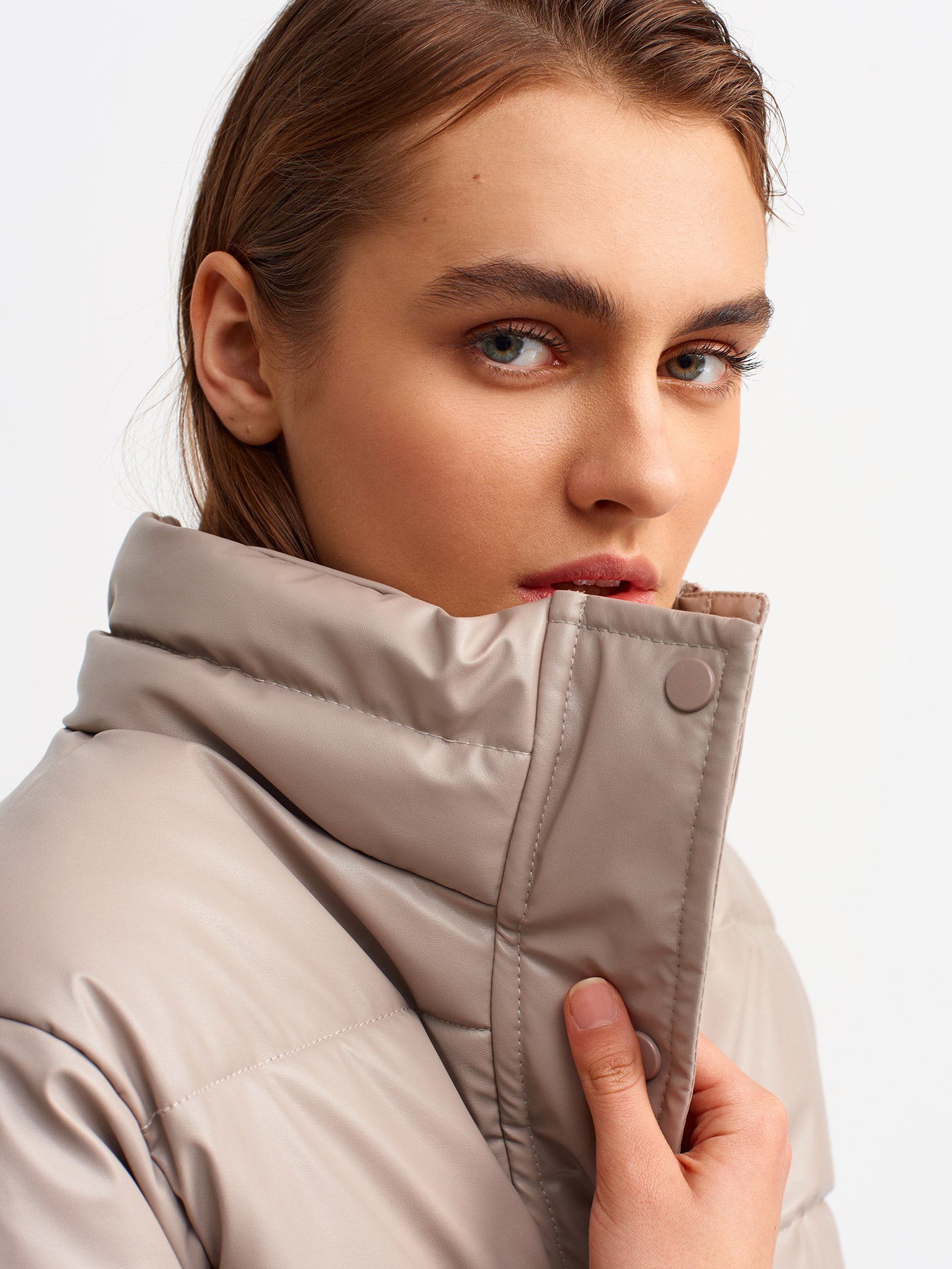 A stylish inflatable coat made from polyester and polyurethane, showcasing its lightweight and water-resistant features.