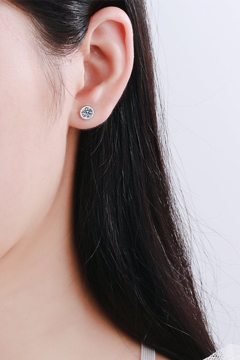 A pair of elegant Inlaid 1 Carat Moissanite Stud Earrings set in 925 sterling silver, showcasing their brilliant sparkle.