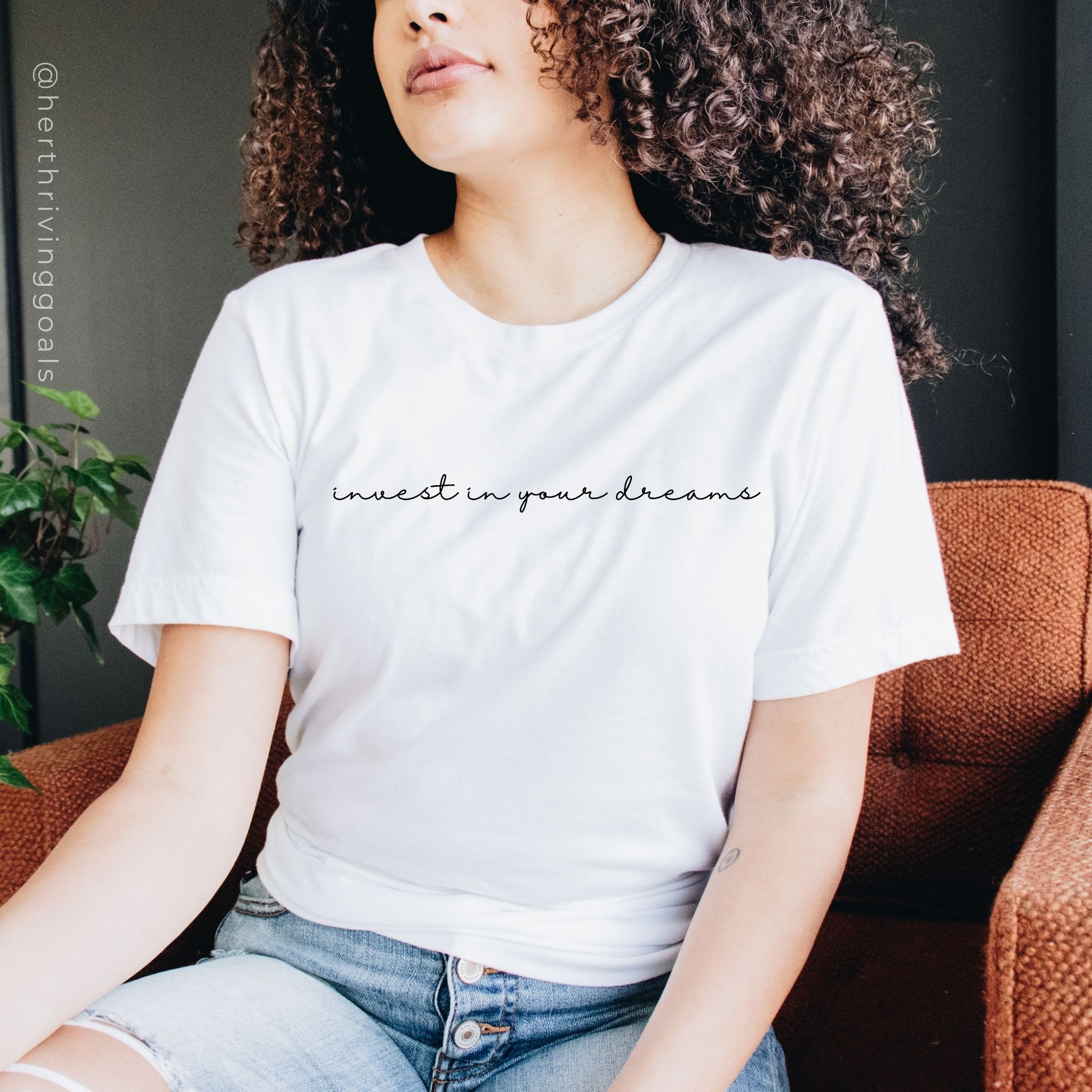 A stylish black t-shirt with the phrase 'Invest in Your Dreams' printed in bold letters, symbolizing motivation for entrepreneurs.