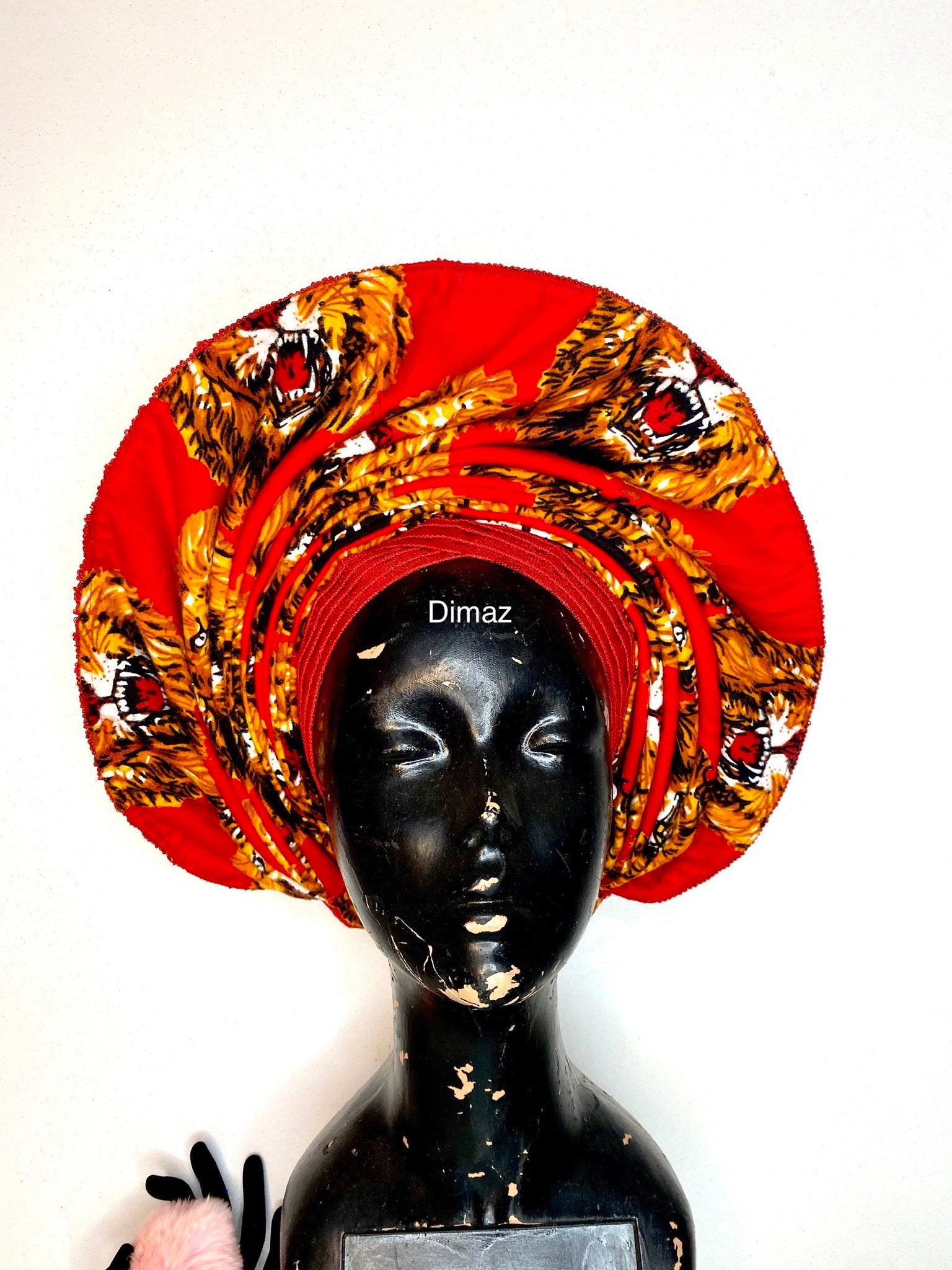 A beautifully crafted Isiagu gele hat made from vibrant isiagu fabric, symbolizing strength and elegance, perfect for cultural events.