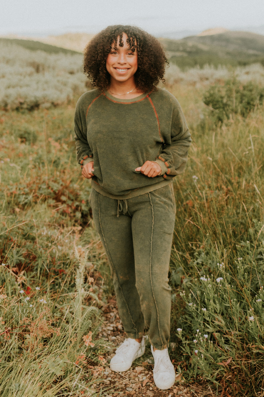 A pair of stylish It’s All Good Joggers in orange, featuring a drawstring waist, pockets, and elastic hem, showcasing a modern front seam design.