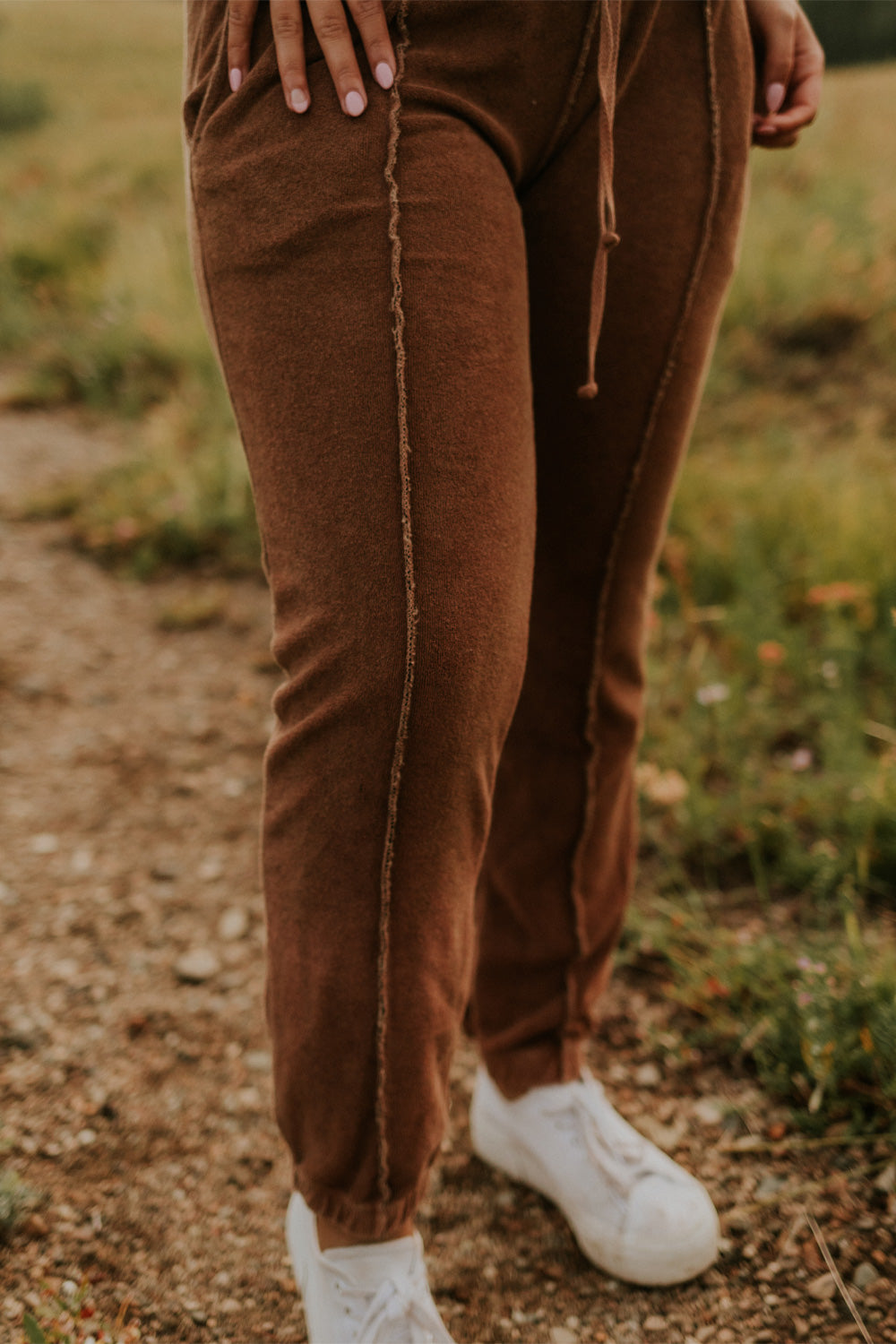 A pair of stylish It’s All Good Joggers in orange, featuring a drawstring waist, pockets, and elastic hem, showcasing a modern front seam design.