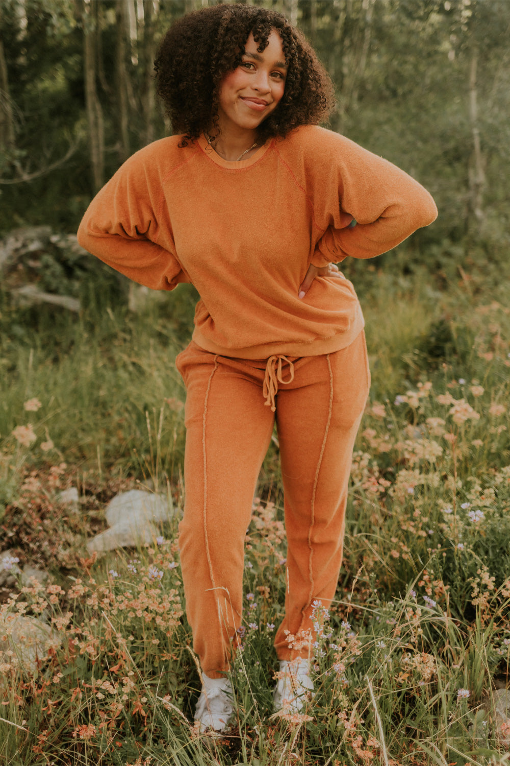 A pair of stylish It’s All Good Joggers in orange, featuring a drawstring waist, pockets, and elastic hem, showcasing a modern front seam design.