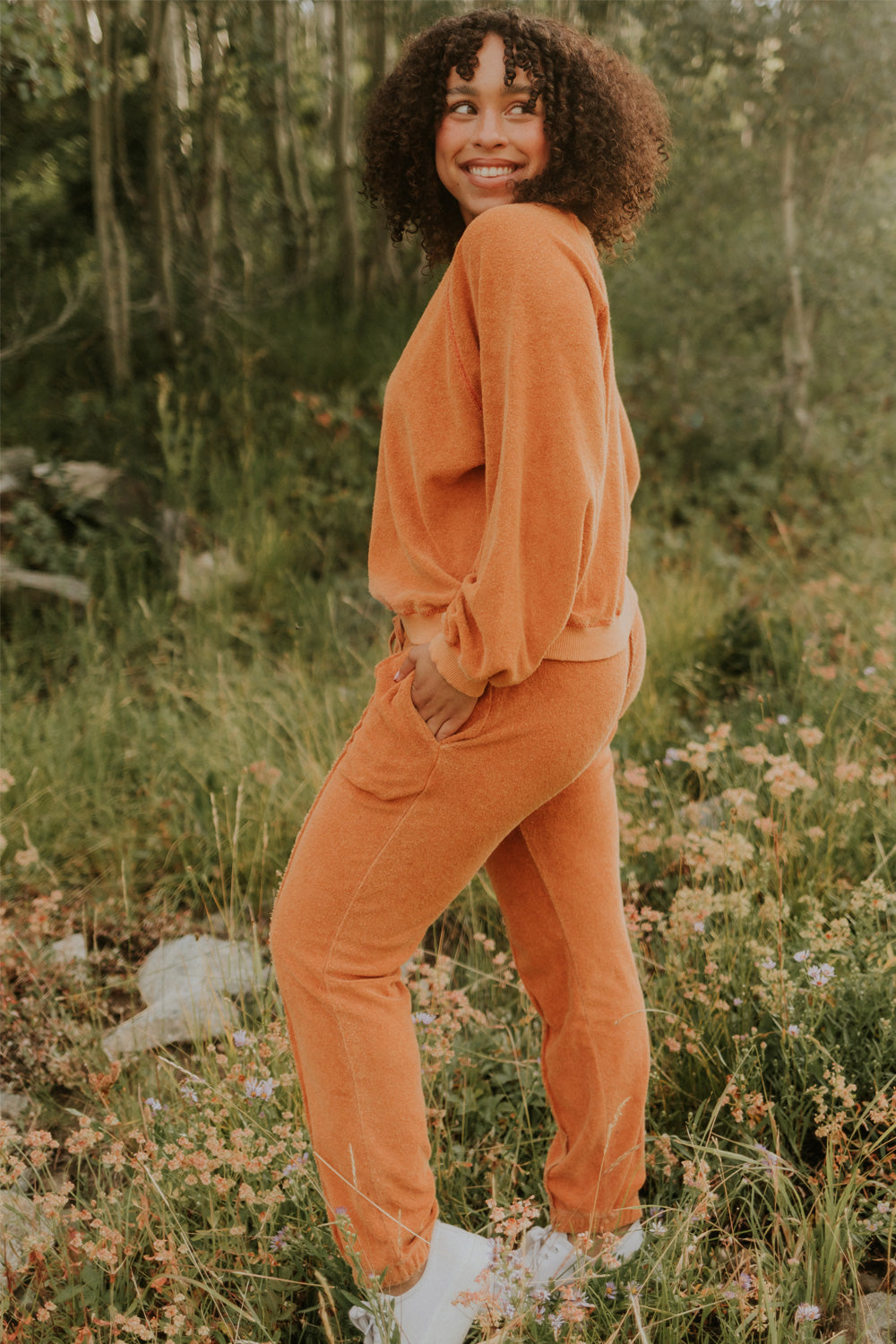 A pair of stylish It’s All Good Joggers in orange, featuring a drawstring waist, pockets, and elastic hem, showcasing a modern front seam design.