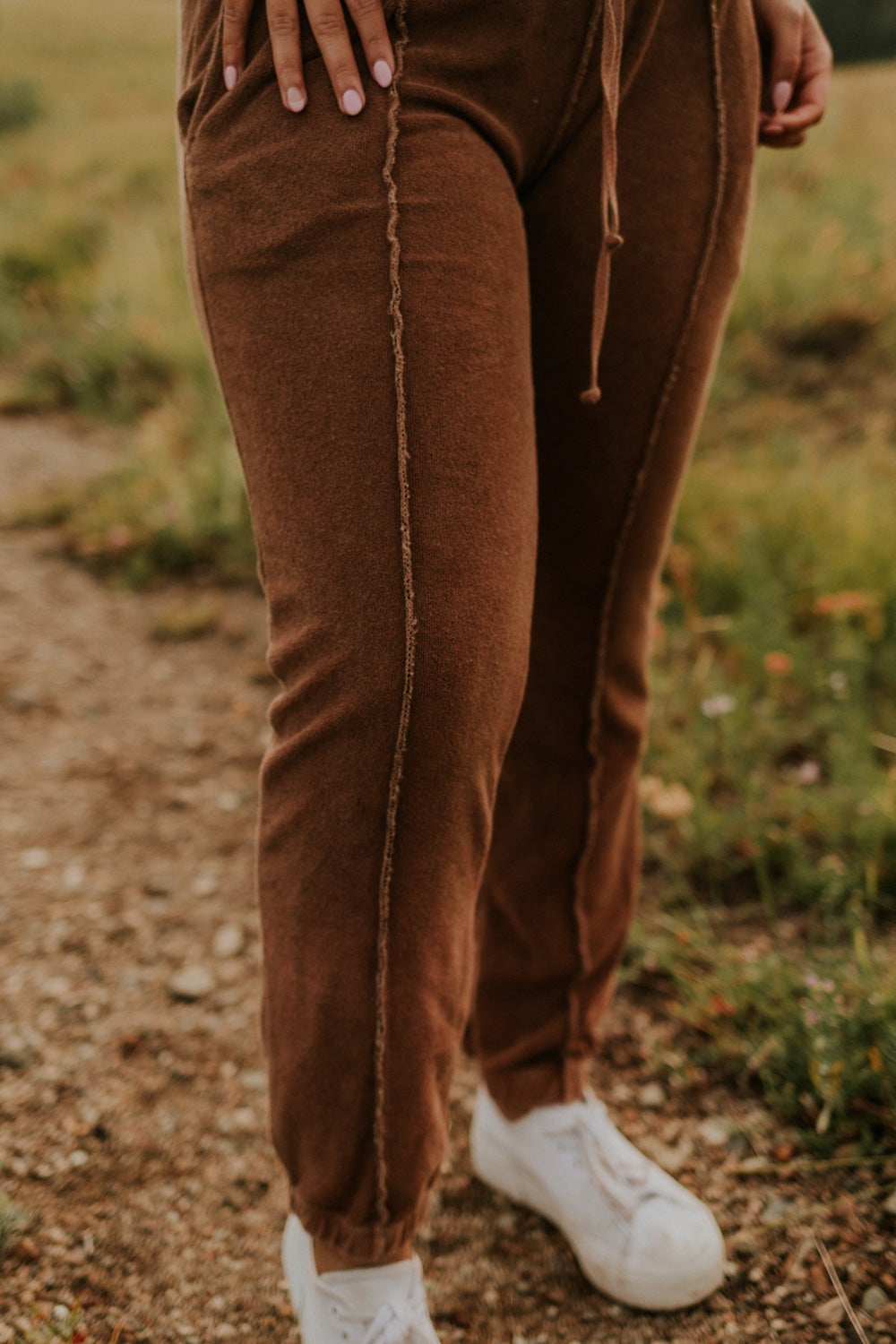 A pair of stylish It’s All Good Joggers in orange, featuring a drawstring waist, pockets, and elastic hem, showcasing a modern front seam design.