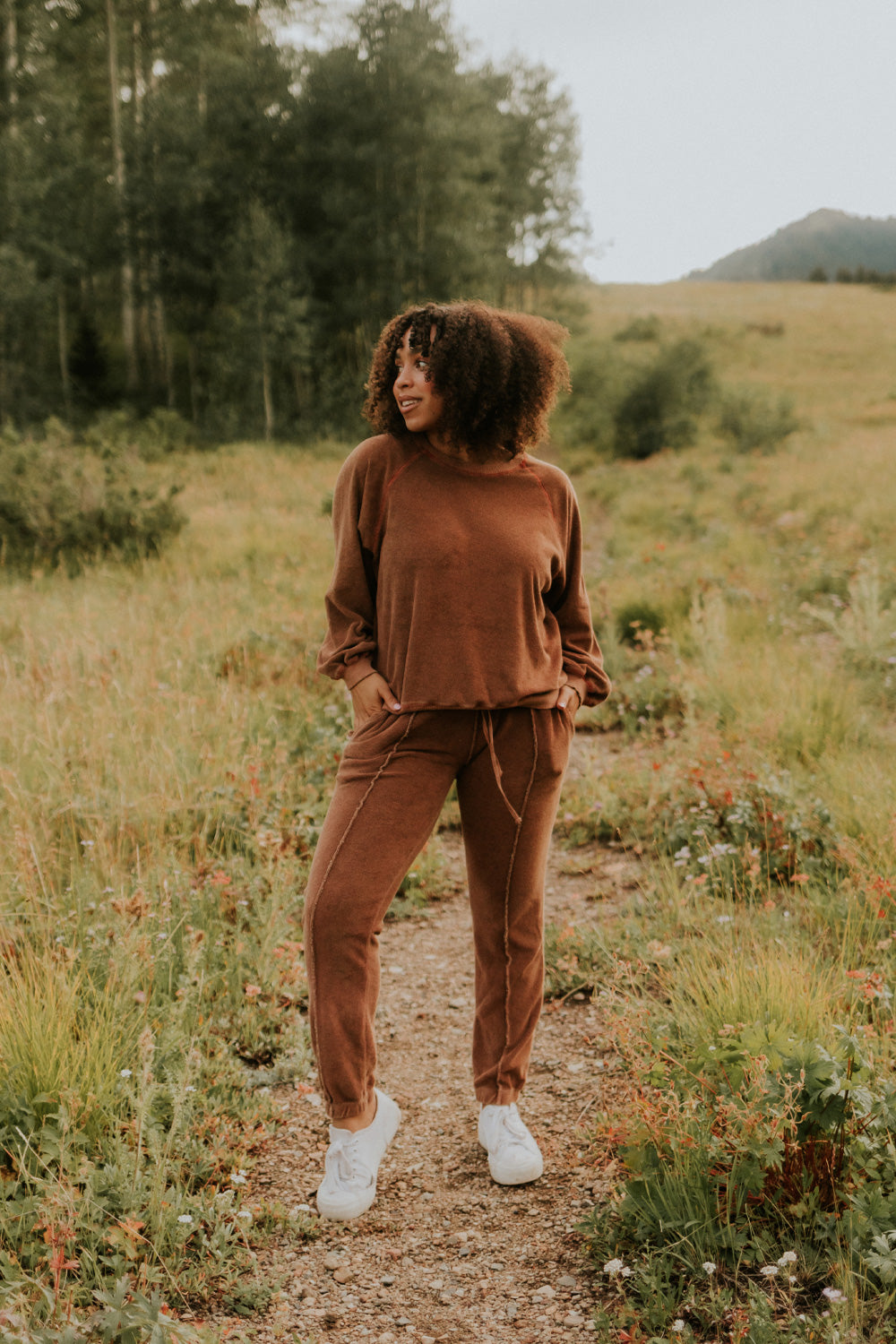 A pair of stylish It’s All Good Joggers in orange, featuring a drawstring waist, pockets, and elastic hem, showcasing a modern front seam design.