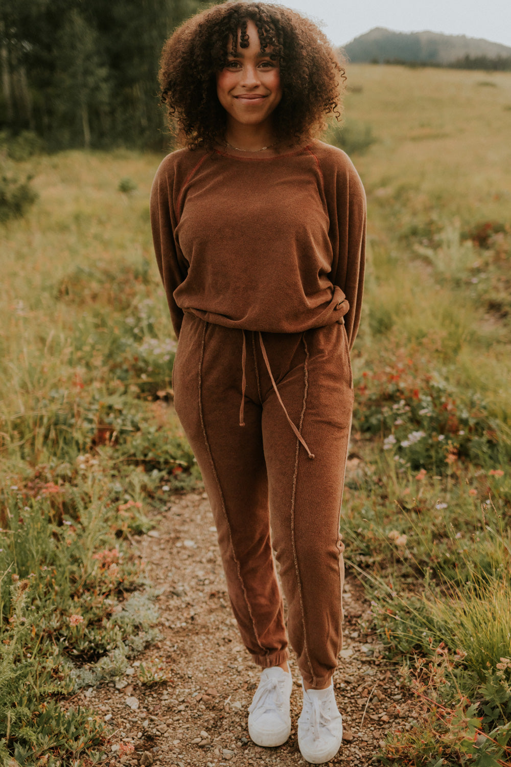 A pair of stylish It’s All Good Joggers in orange, featuring a drawstring waist, pockets, and elastic hem, showcasing a modern front seam design.