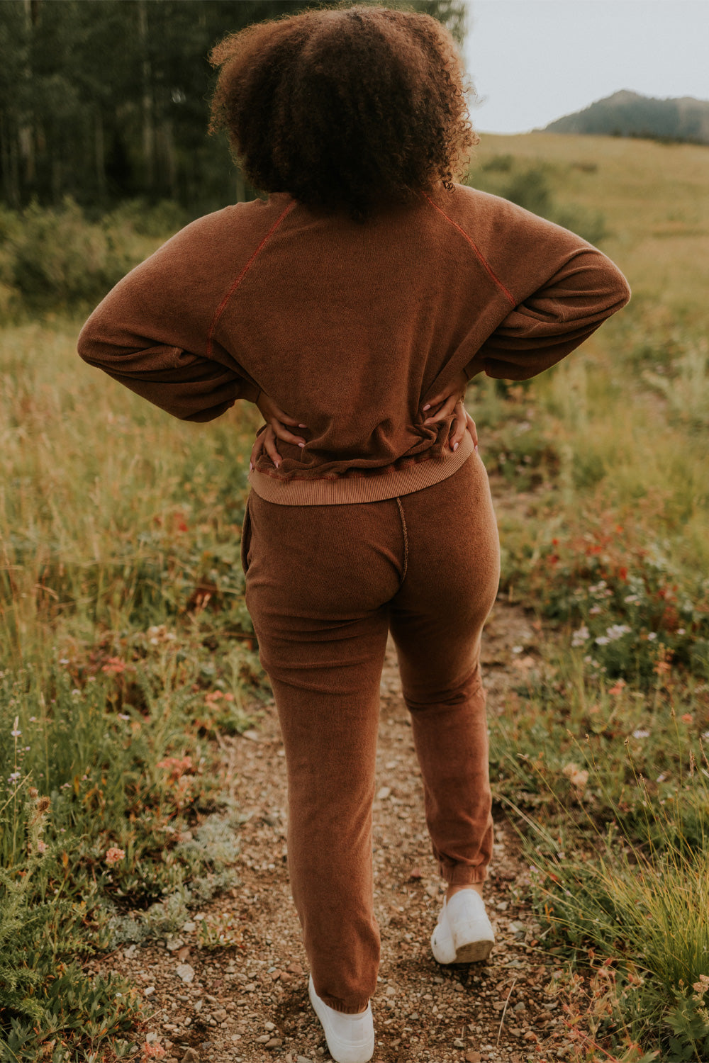 A pair of stylish It’s All Good Joggers in orange, featuring a drawstring waist, pockets, and elastic hem, showcasing a modern front seam design.