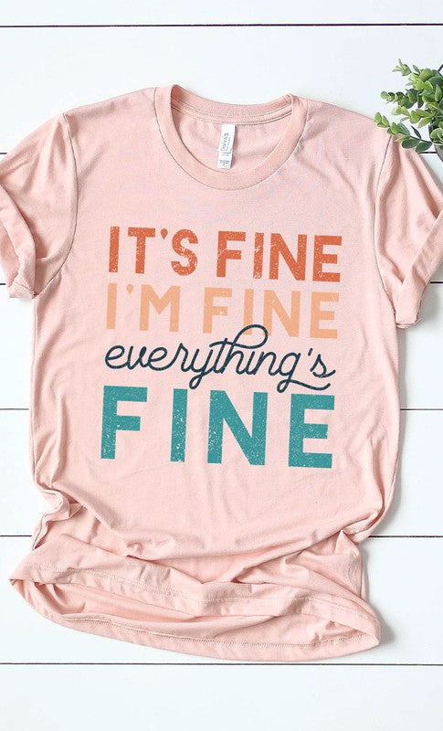 A stylish white graphic tee featuring the text 'It's Fine I'm Fine Everything's Fine' in a playful font, made from soft cotton material.