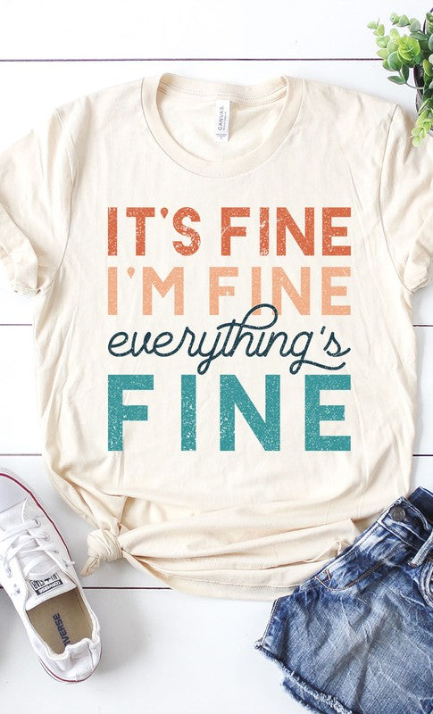 A stylish white graphic tee featuring the text 'It's Fine I'm Fine Everything's Fine' in a playful font, made from soft cotton material.