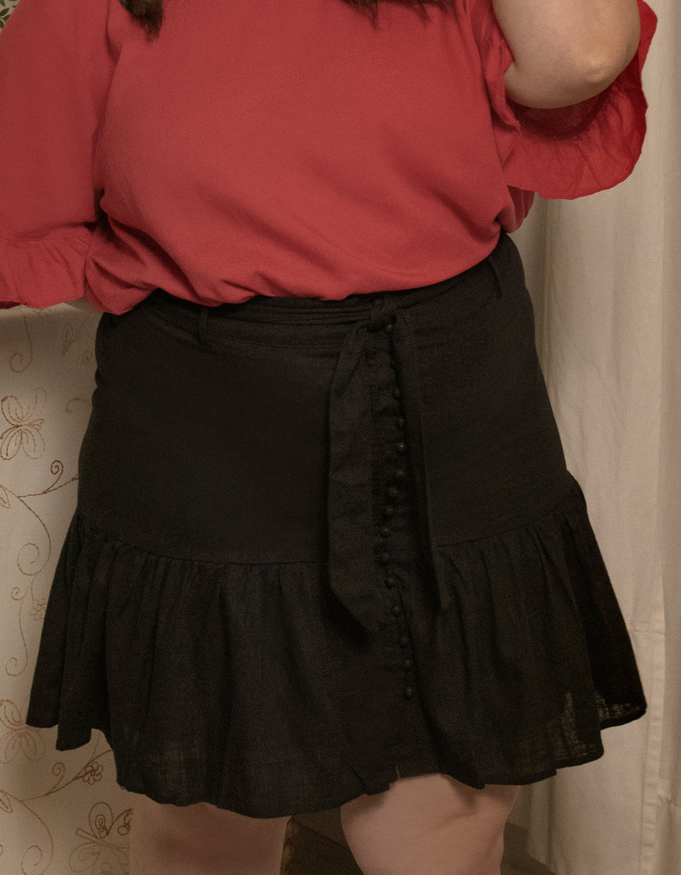 Jasmine Skirt in solid black, featuring a high-waisted design, removable self-belt, and vintage-inspired self-covered buttons.