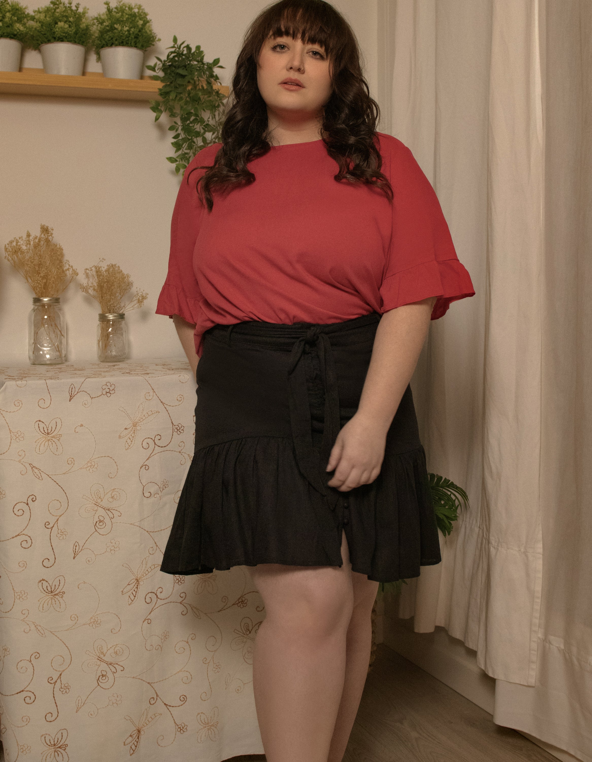 Jasmine Skirt in solid black, featuring a high-waisted design, removable self-belt, and vintage-inspired self-covered buttons.