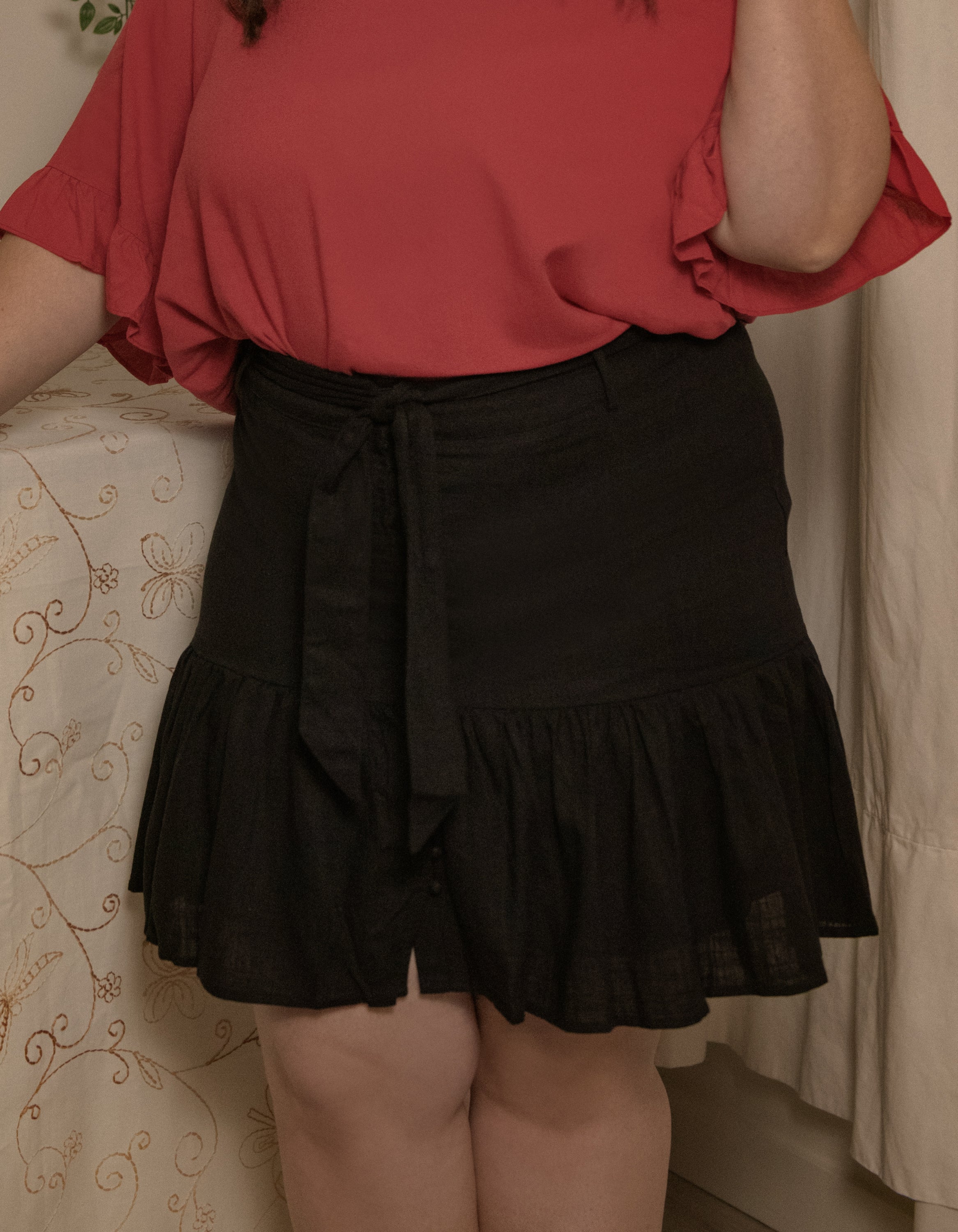 Jasmine Skirt in solid black, featuring a high-waisted design, removable self-belt, and vintage-inspired self-covered buttons.