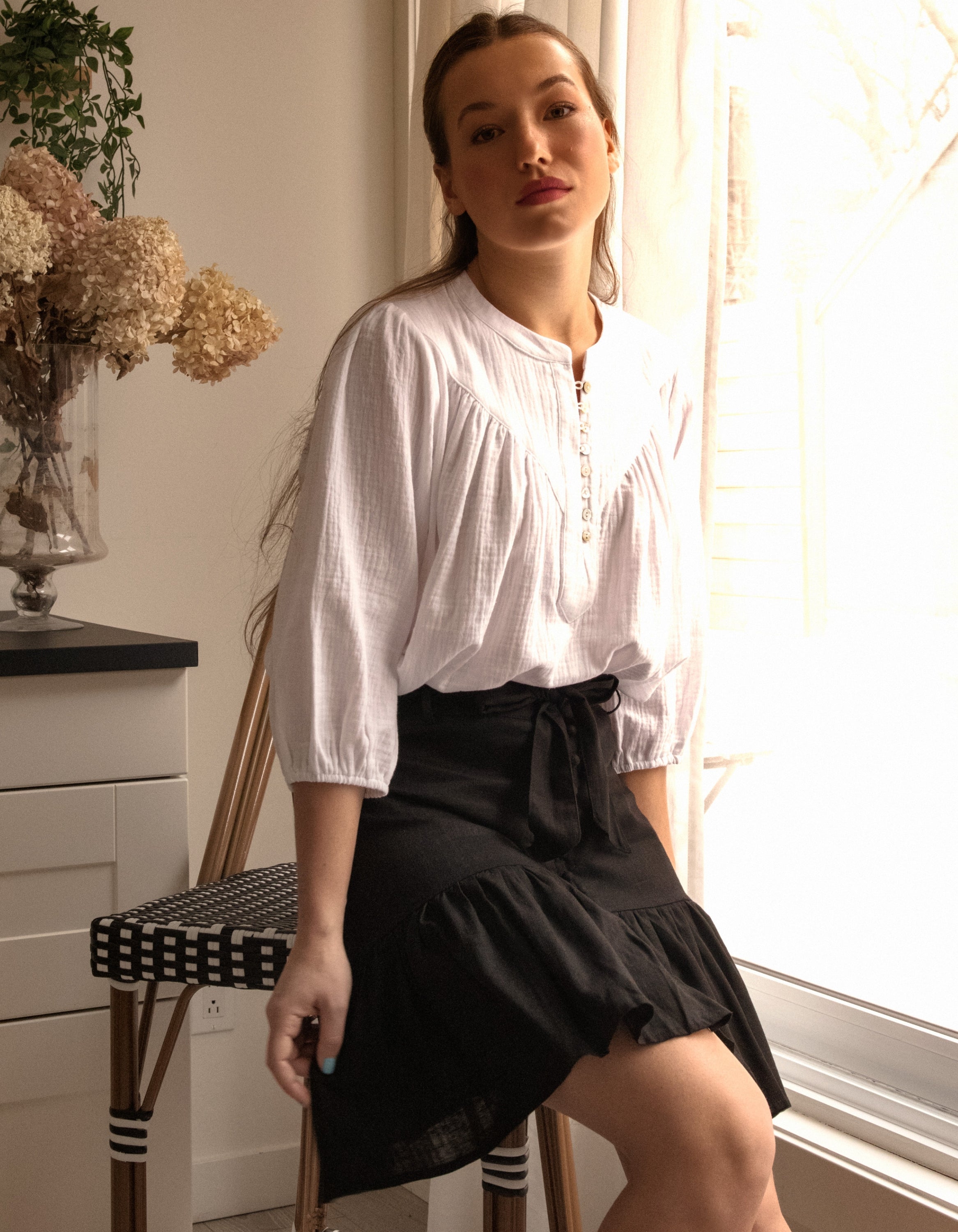 Jasmine Skirt in solid black, featuring a high-waisted design, removable self-belt, and vintage-inspired self-covered buttons.