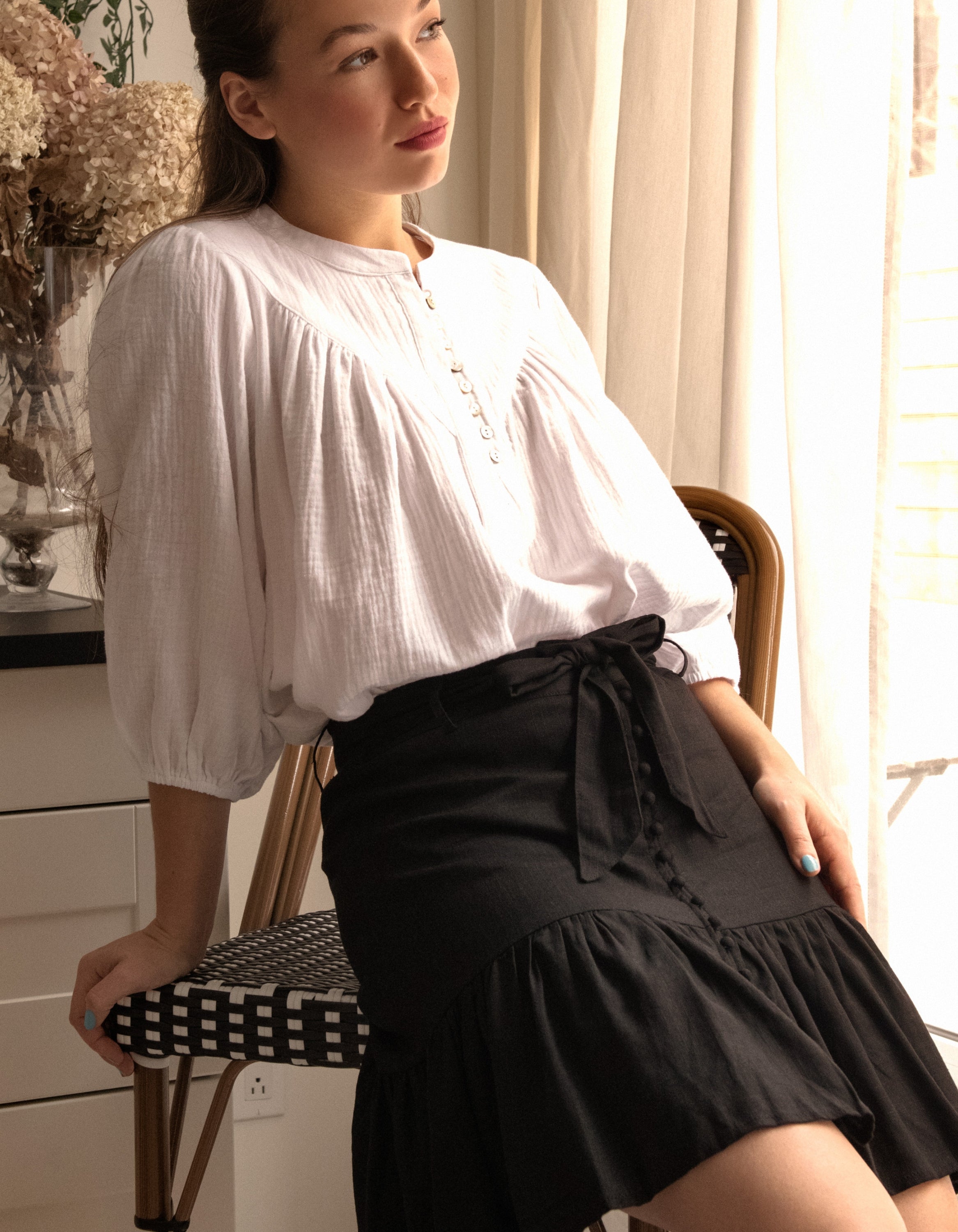 Jasmine Skirt in solid black, featuring a high-waisted design, removable self-belt, and vintage-inspired self-covered buttons.