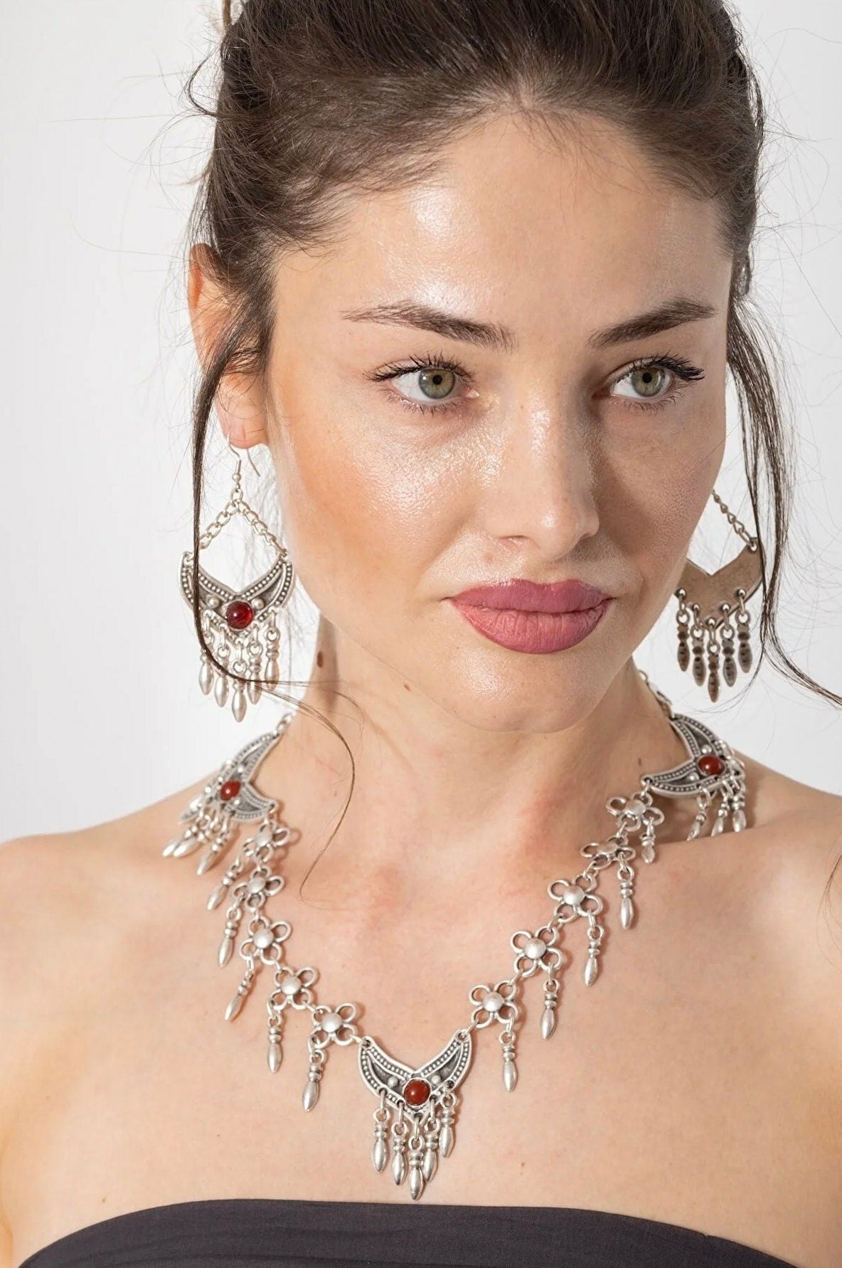 A beautiful Bohemian jewelry set featuring antique silver plated earrings and necklace, showcasing intricate designs and adjustable features.