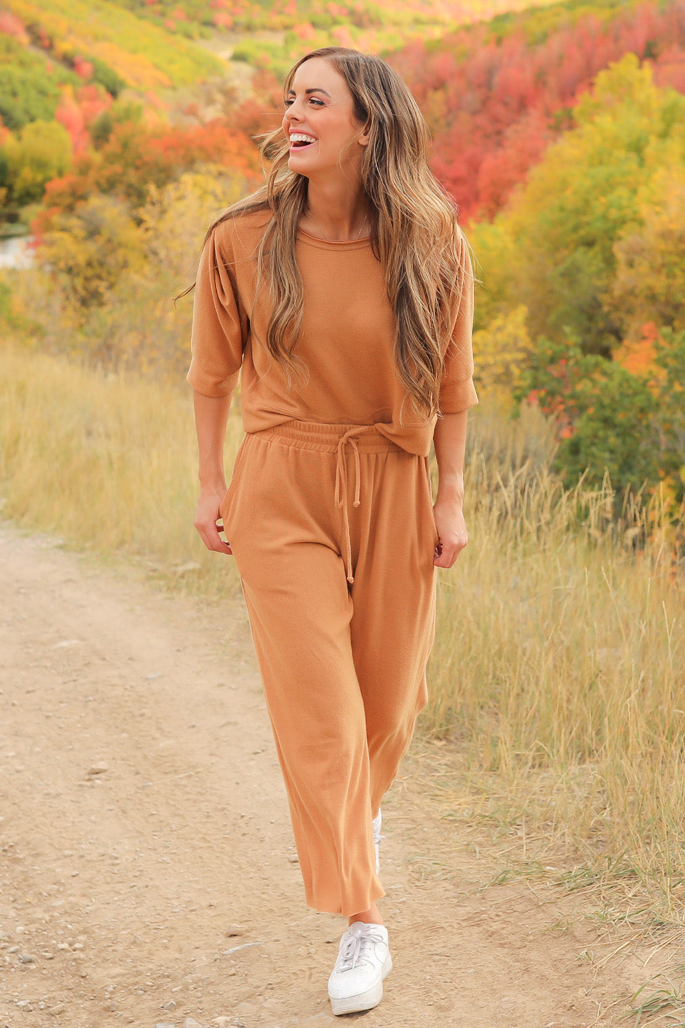 A pair of Journey Pants in brown, featuring a slouchy fit, cropped length, and drawstring waist, with pockets visible.