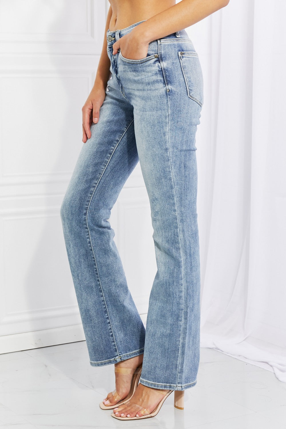 Judy Blue Full Size Maddison Midrise Bootcut Jeans displayed on a mannequin, showcasing the stylish bootcut design and high-quality fabric.