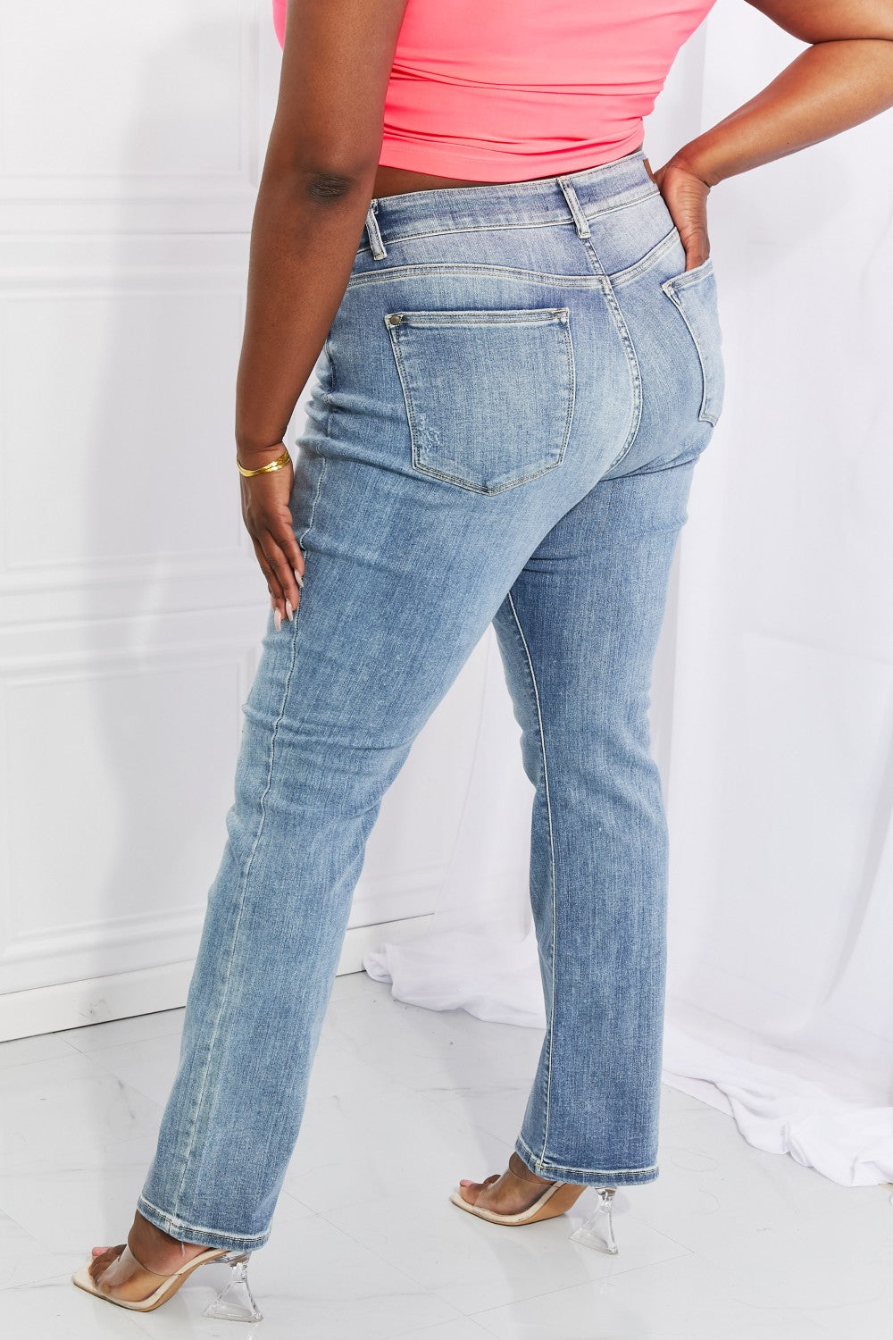 Judy Blue Full Size Maddison Midrise Bootcut Jeans displayed on a mannequin, showcasing the stylish bootcut design and high-quality fabric.