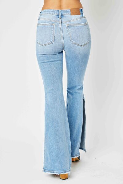 Judy Blue Full Size Mid Rise Raw Hem Slit Flare Jeans showcasing a light wash with a stylish raw hem and slit flare design.