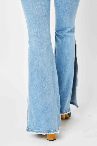 Judy Blue Full Size Mid Rise Raw Hem Slit Flare Jeans showcasing a light wash with a stylish raw hem and slit flare design.