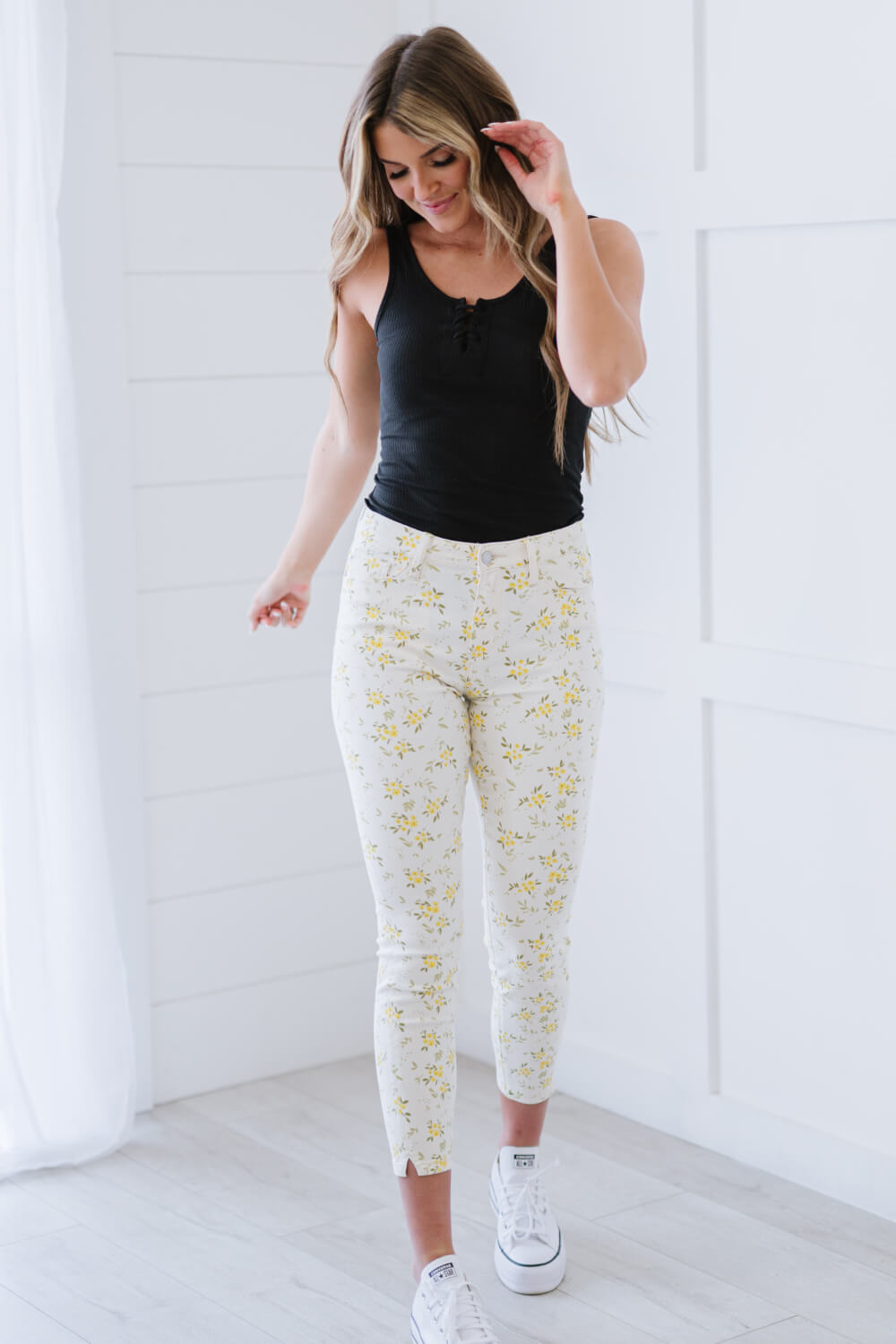 Judy Blue Golden Meadow Floral Skinny Jeans featuring a vibrant yellow floral pattern, mid-rise waist, and a slim fit design.