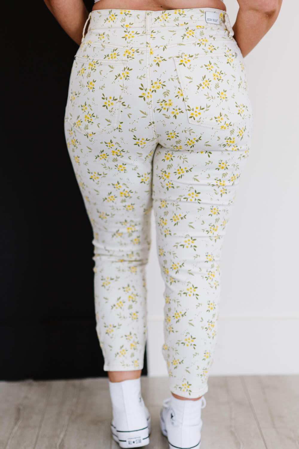 Judy Blue Golden Meadow Floral Skinny Jeans featuring a vibrant yellow floral pattern, mid-rise waist, and a slim fit design.