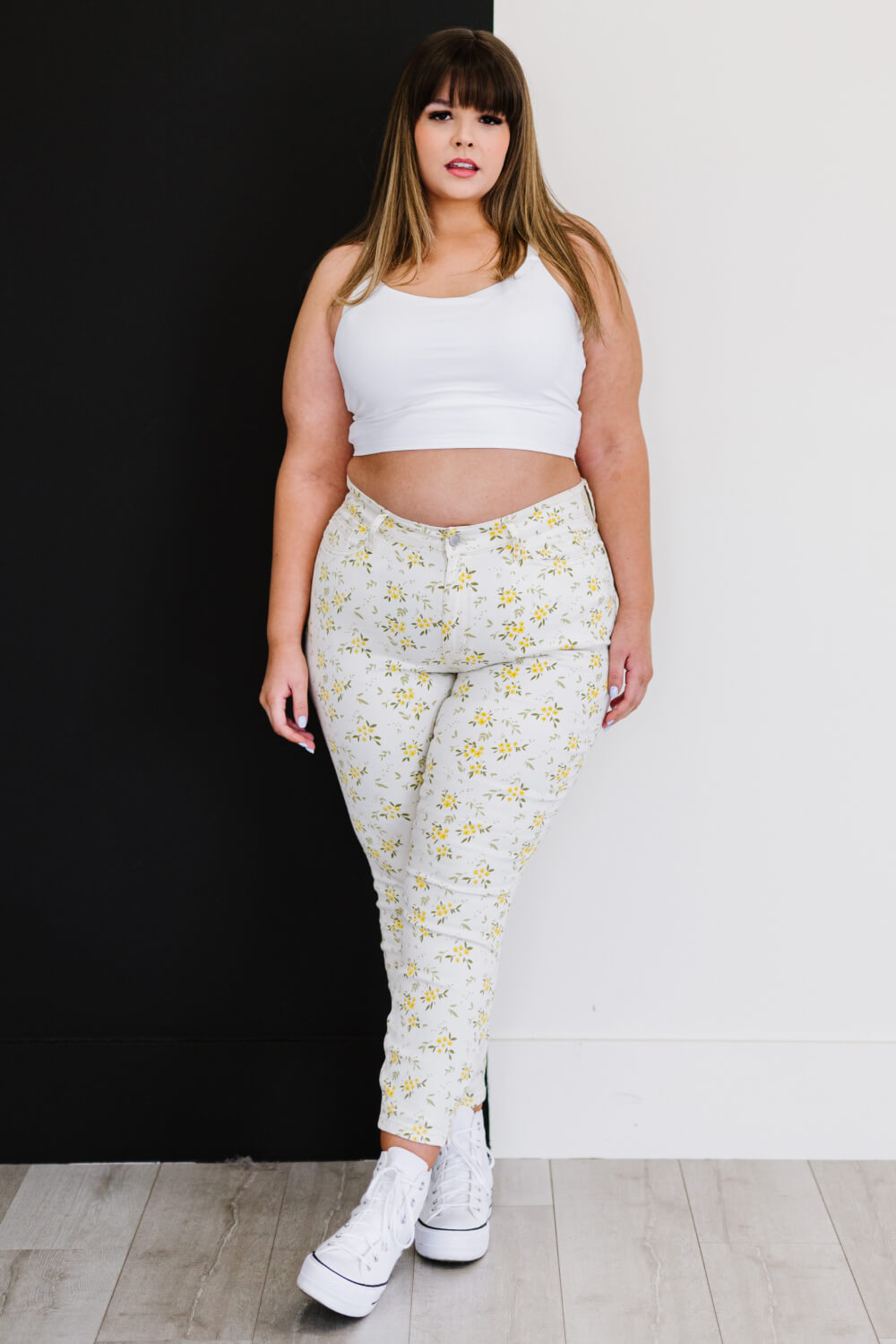 Judy Blue Golden Meadow Floral Skinny Jeans featuring a vibrant yellow floral pattern, mid-rise waist, and a slim fit design.