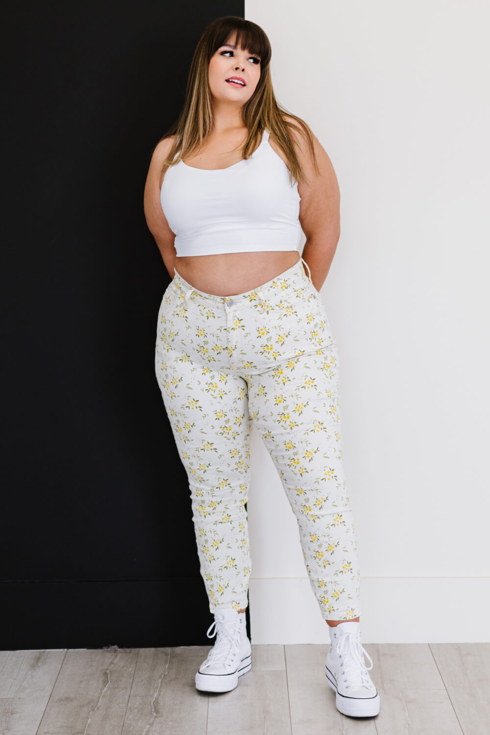 Judy Blue Golden Meadow Floral Skinny Jeans featuring a vibrant yellow floral pattern, mid-rise waist, and a slim fit design.