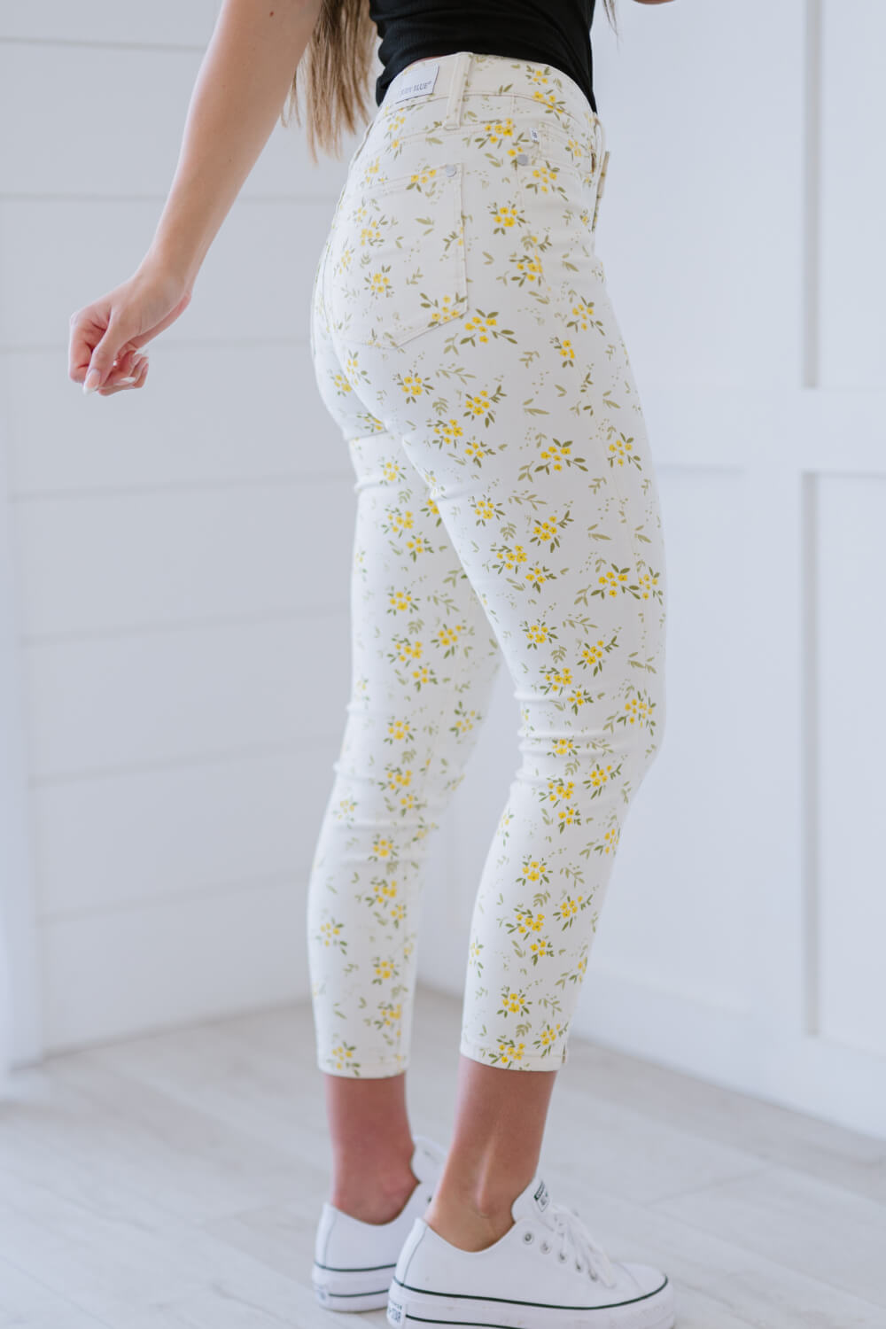 Judy Blue Golden Meadow Floral Skinny Jeans featuring a vibrant yellow floral pattern, mid-rise waist, and a slim fit design.