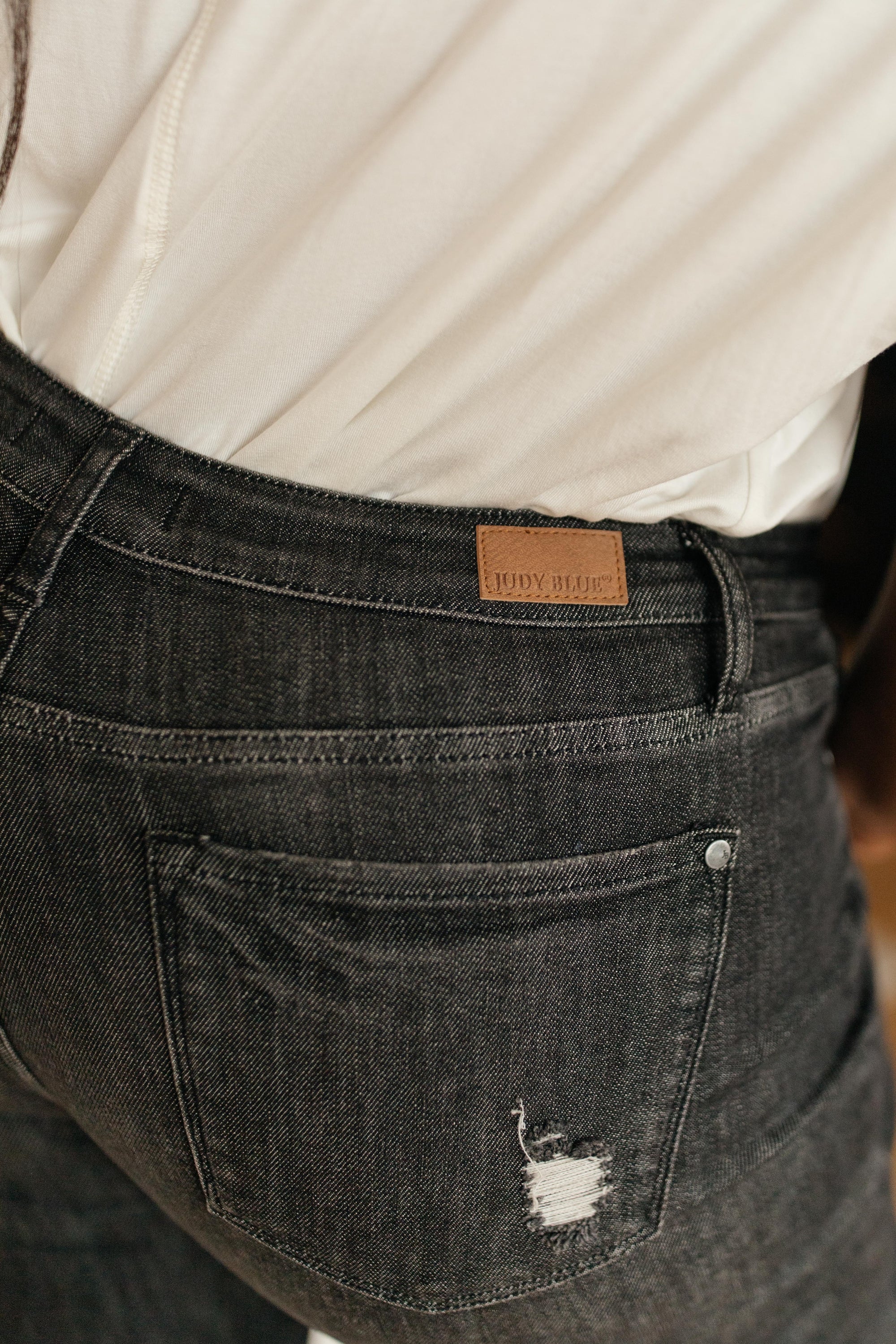 Judy Blue Gray Days Button Rise Jeans featuring a stylish button rise design, distressed detailing at knees, and functional pockets.