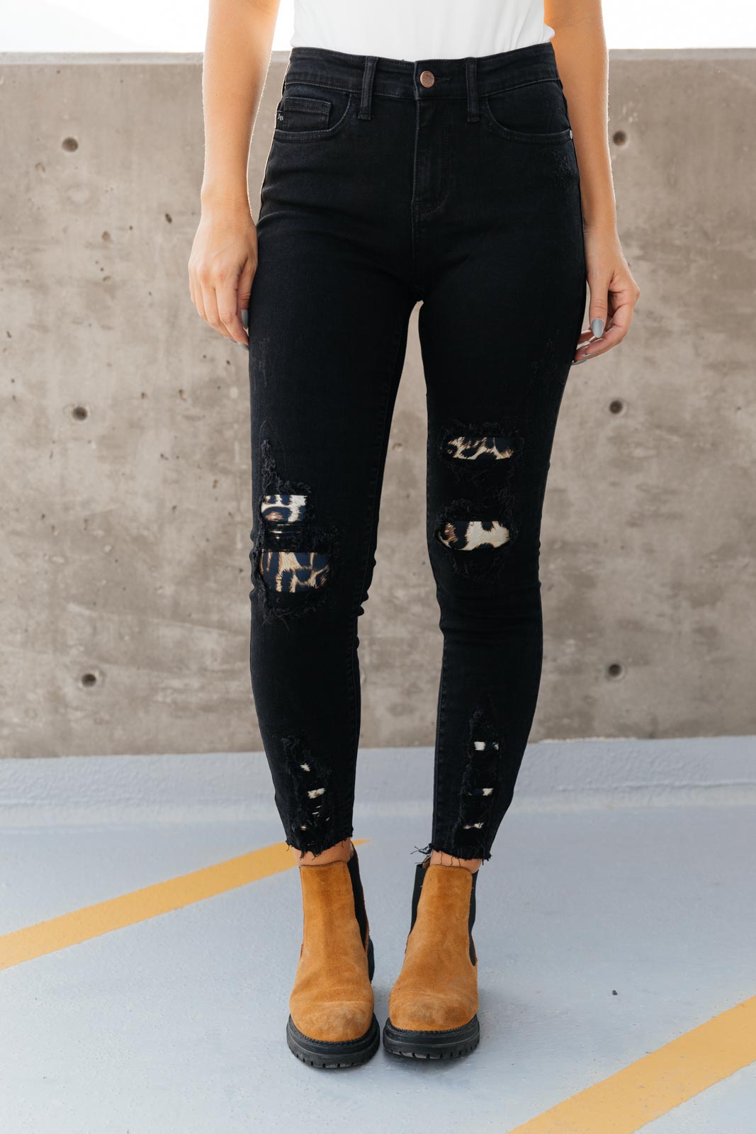 Judy Blue Into The Wild Distressed Skinny Jeans featuring black denim with animal print details and a raw hem.