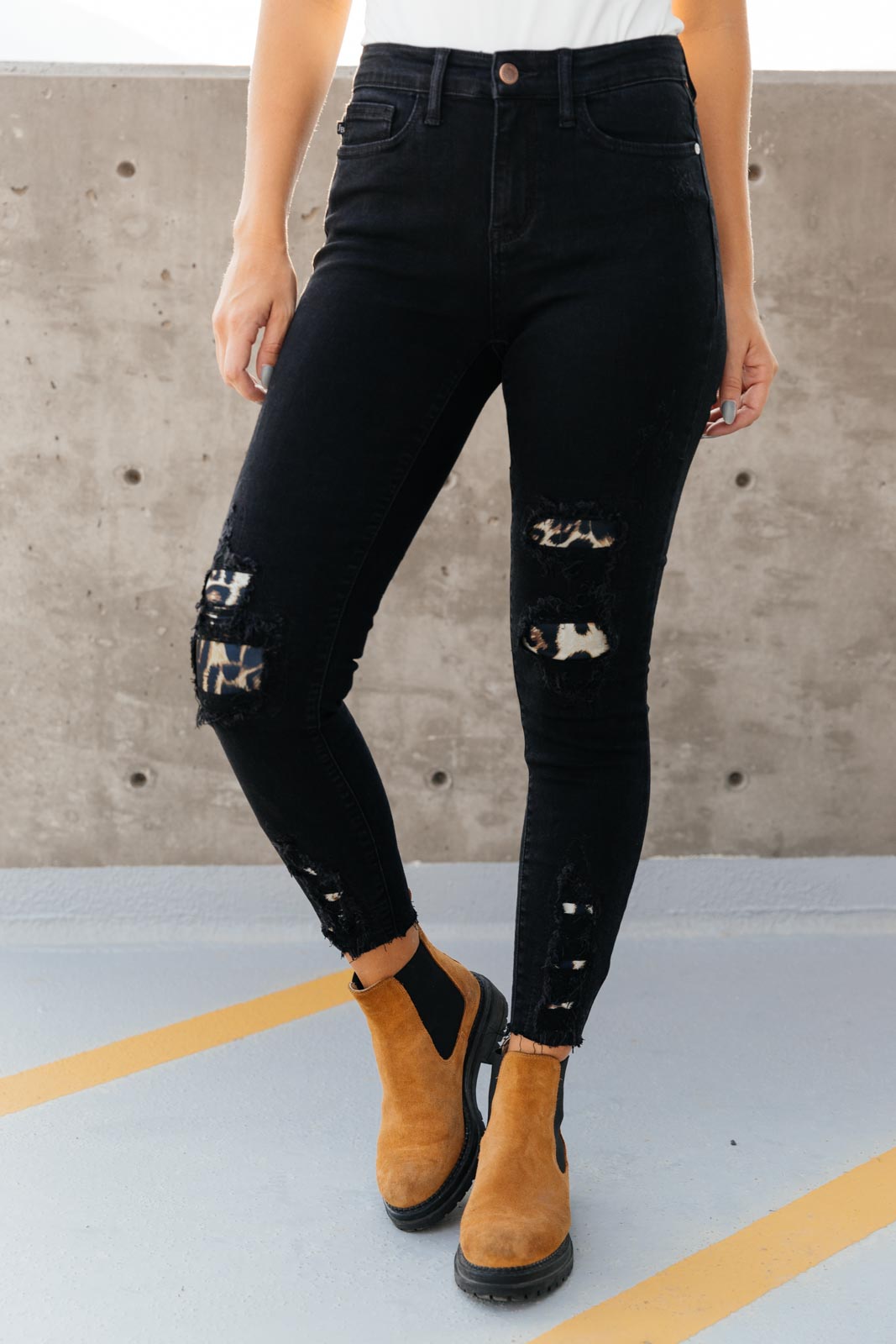 Judy Blue Into The Wild Distressed Skinny Jeans featuring black denim with animal print details and a raw hem.