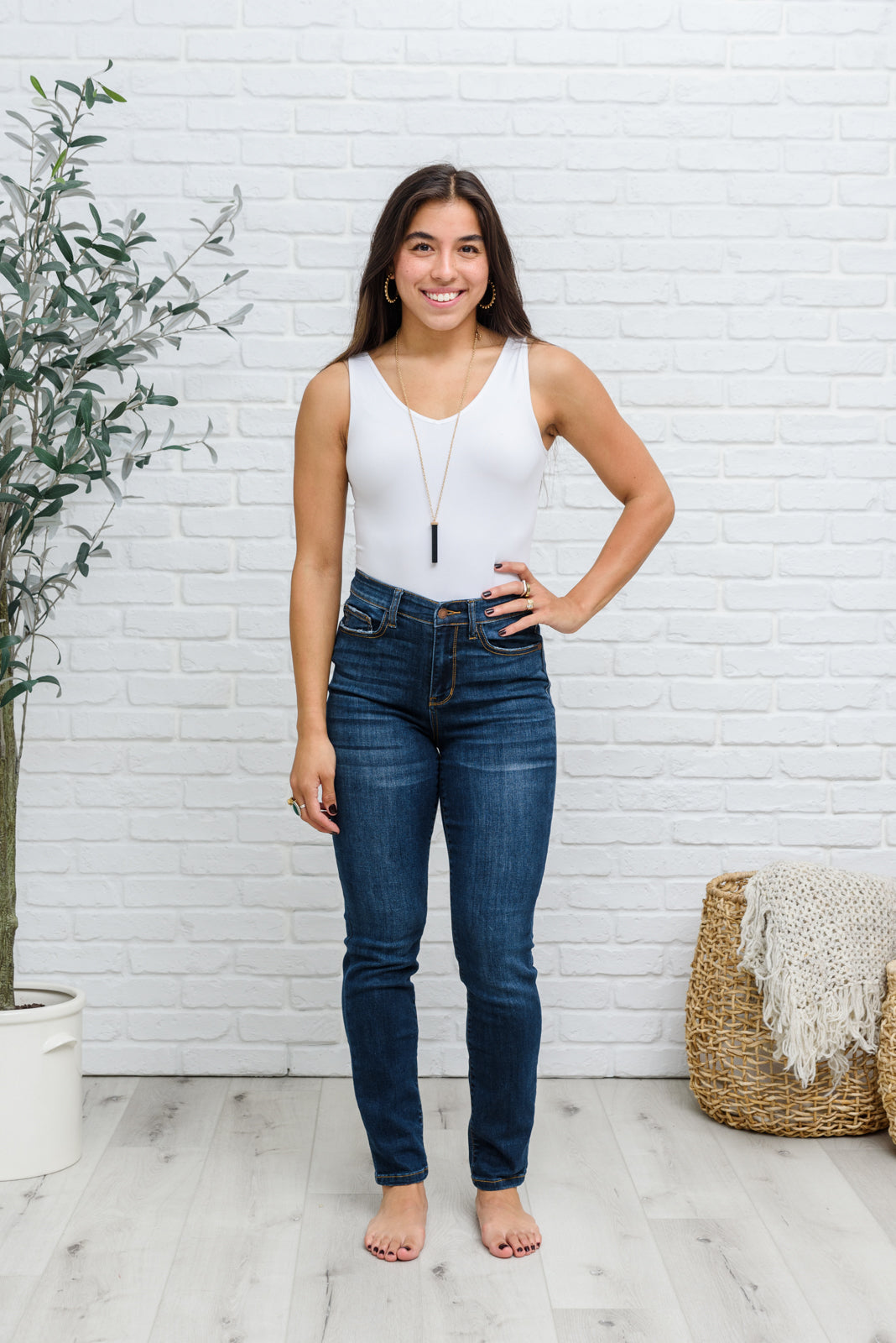 Judy Blue Reba Hi-Rise Clean Relaxed Fit Jeans displayed on a model, showcasing the dark wash denim and relaxed fit.