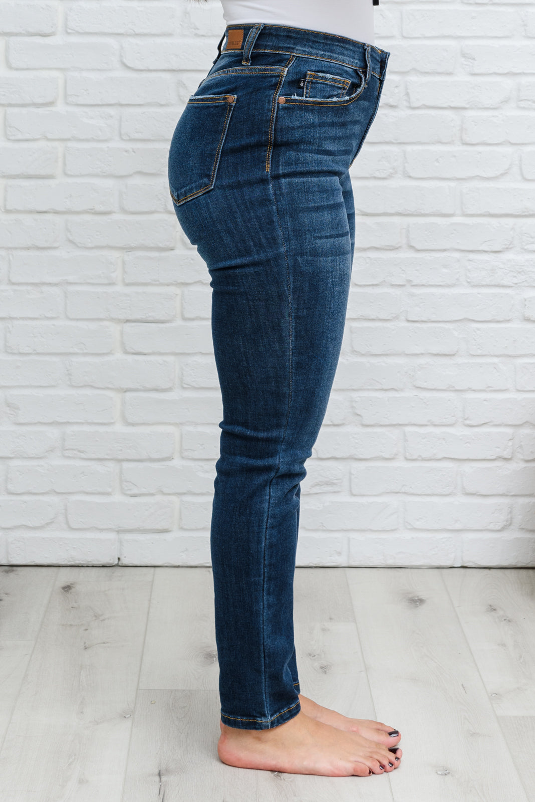 Judy Blue Reba Hi-Rise Clean Relaxed Fit Jeans displayed on a model, showcasing the dark wash denim and relaxed fit.