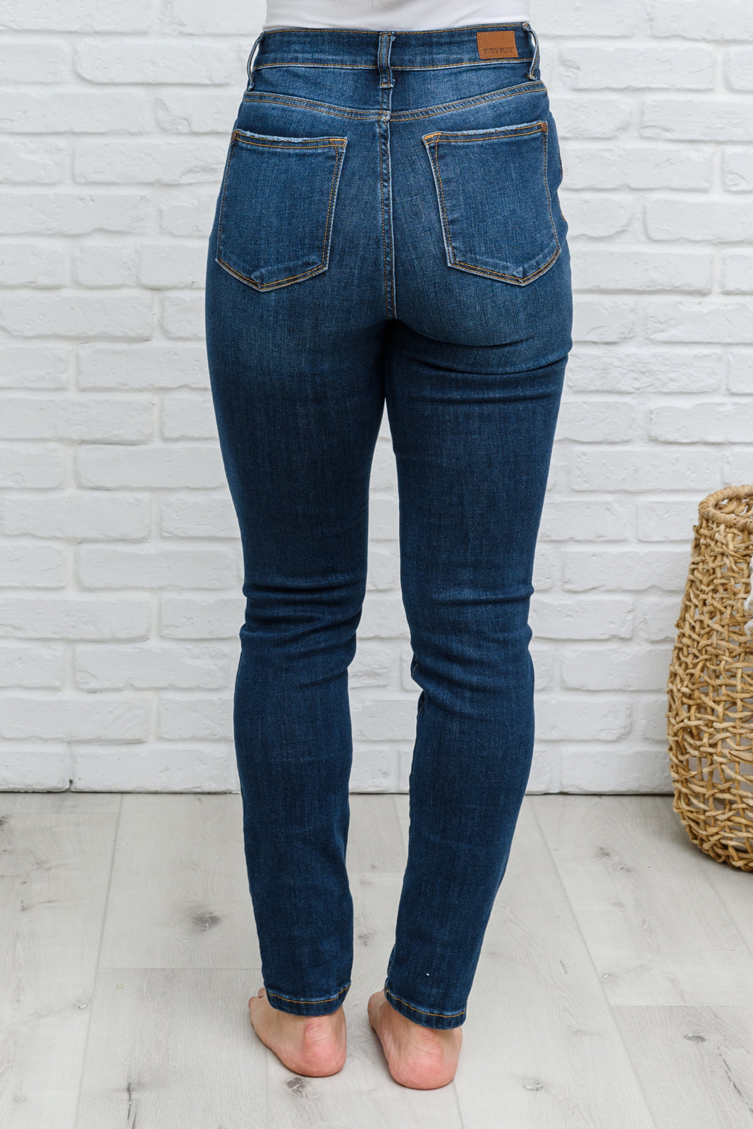 Judy Blue Reba Hi-Rise Clean Relaxed Fit Jeans displayed on a model, showcasing the dark wash denim and relaxed fit.