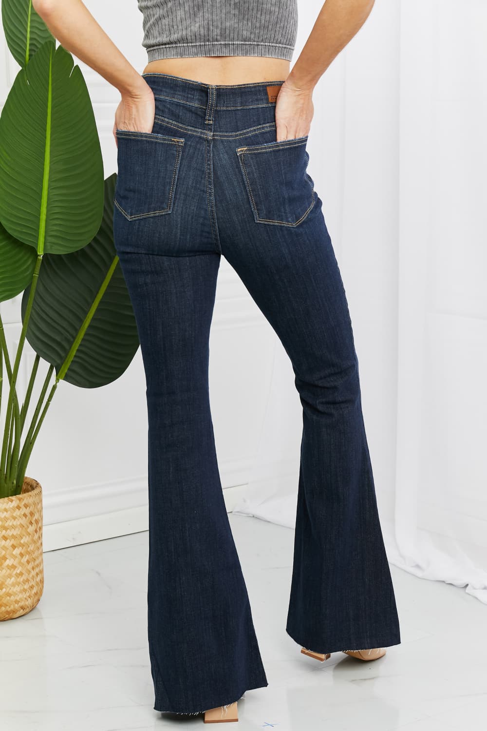 Judy Blue Tiffany Full Size Mid Rise Flare Jeans in dark wash, showcasing the flattering mid-rise waist and flare leg silhouette.