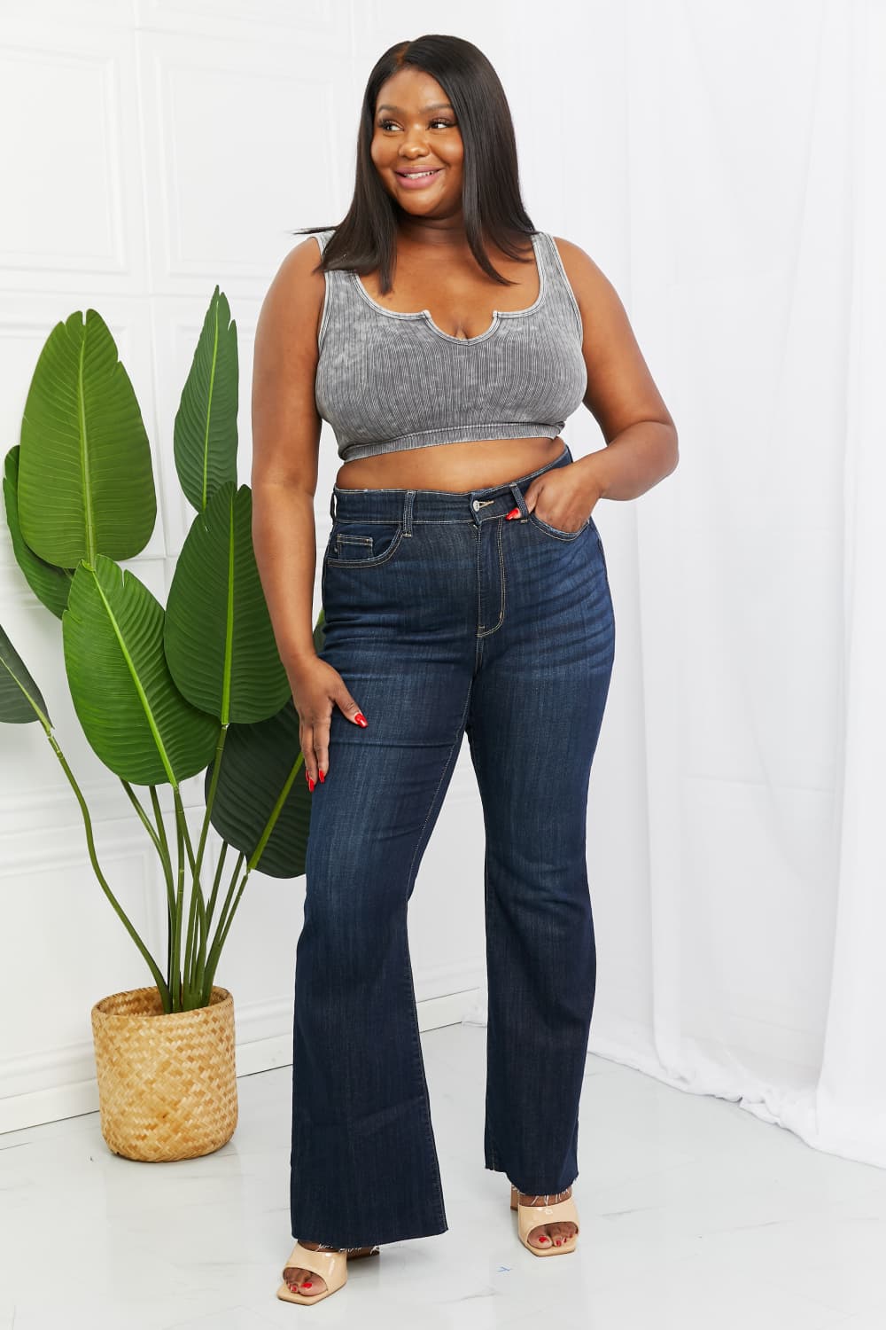 Judy Blue Tiffany Full Size Mid Rise Flare Jeans in dark wash, showcasing the flattering mid-rise waist and flare leg silhouette.