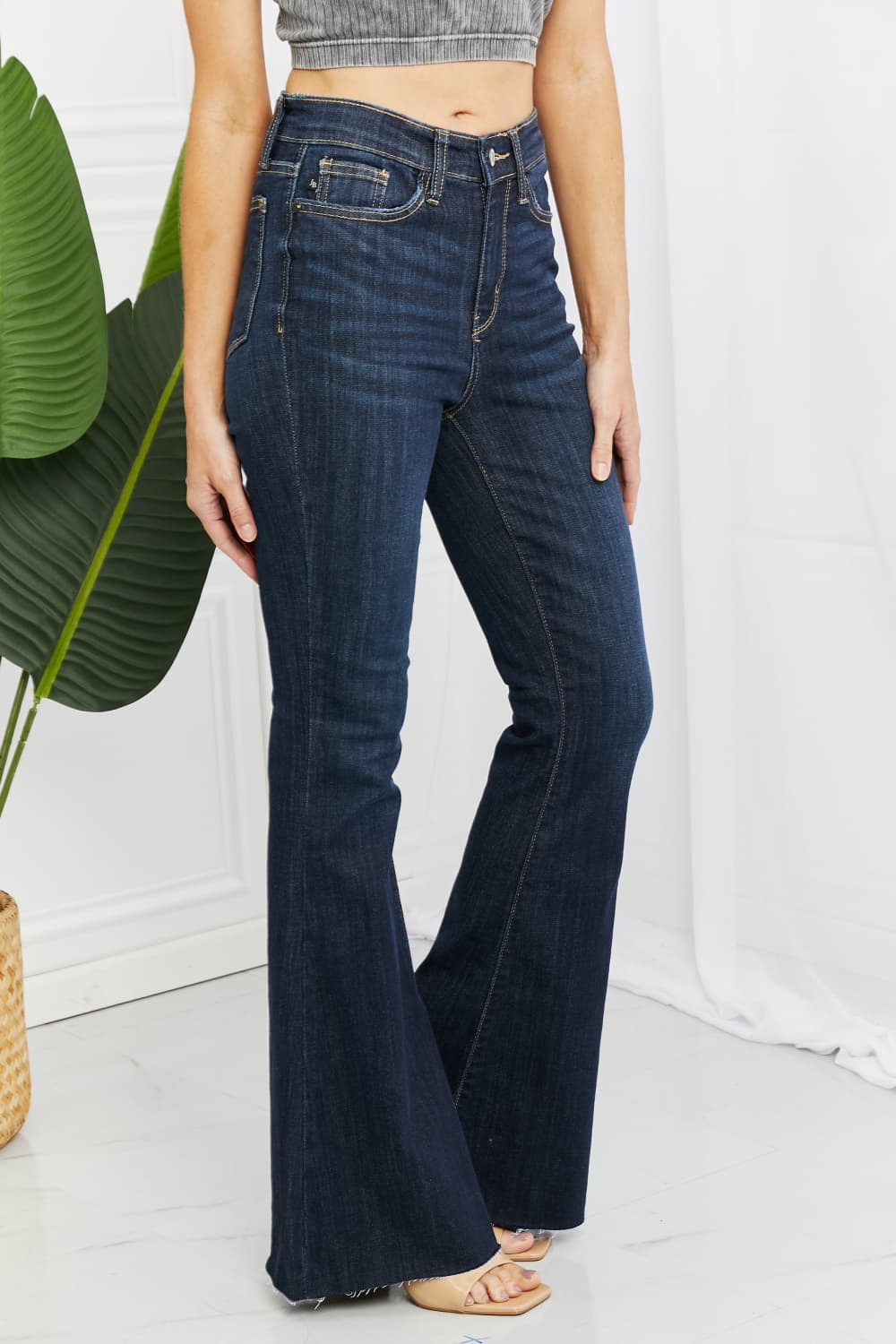 Judy Blue Tiffany Full Size Mid Rise Flare Jeans in dark wash, showcasing the flattering mid-rise waist and flare leg silhouette.