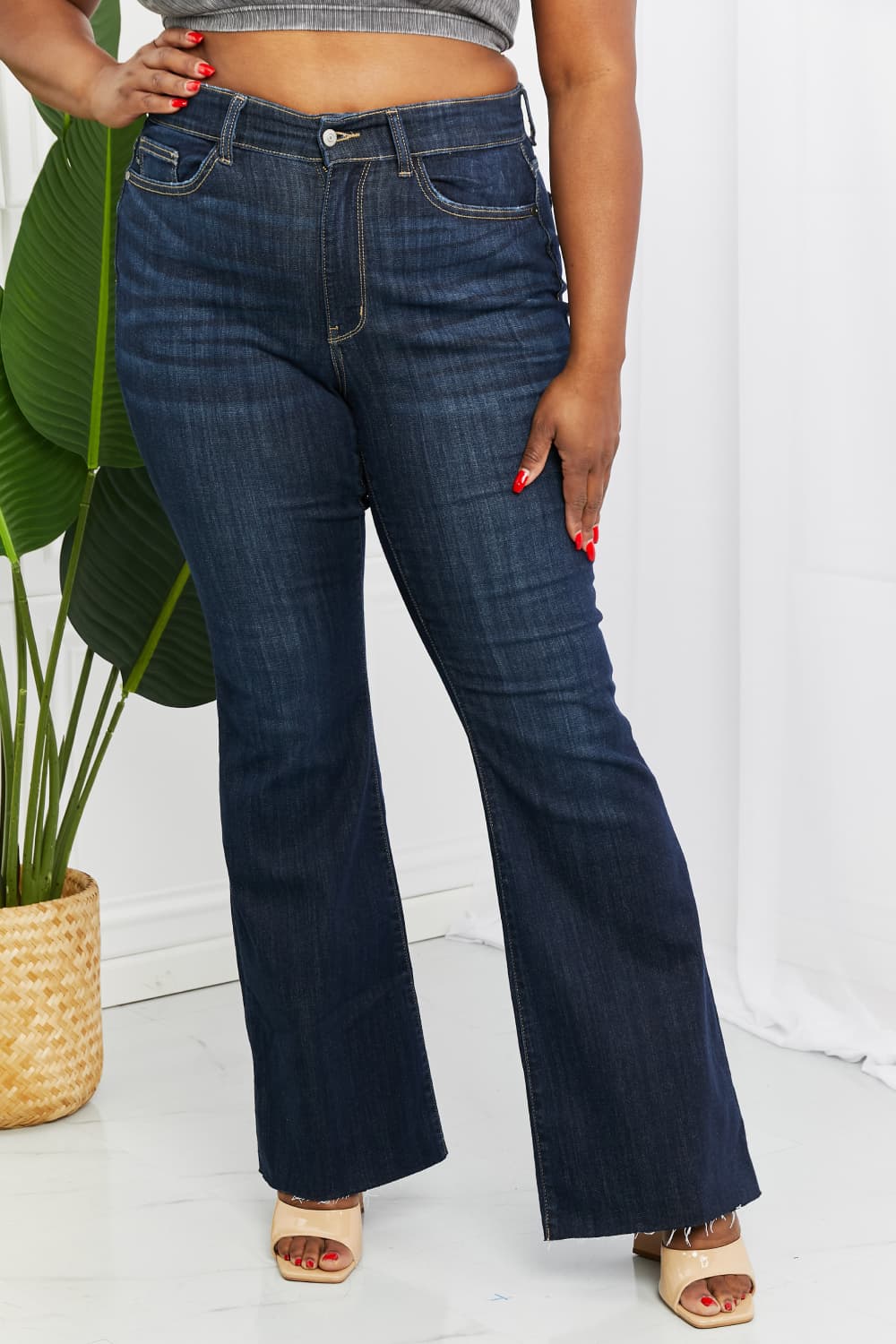 Judy Blue Tiffany Full Size Mid Rise Flare Jeans in dark wash, showcasing the flattering mid-rise waist and flare leg silhouette.