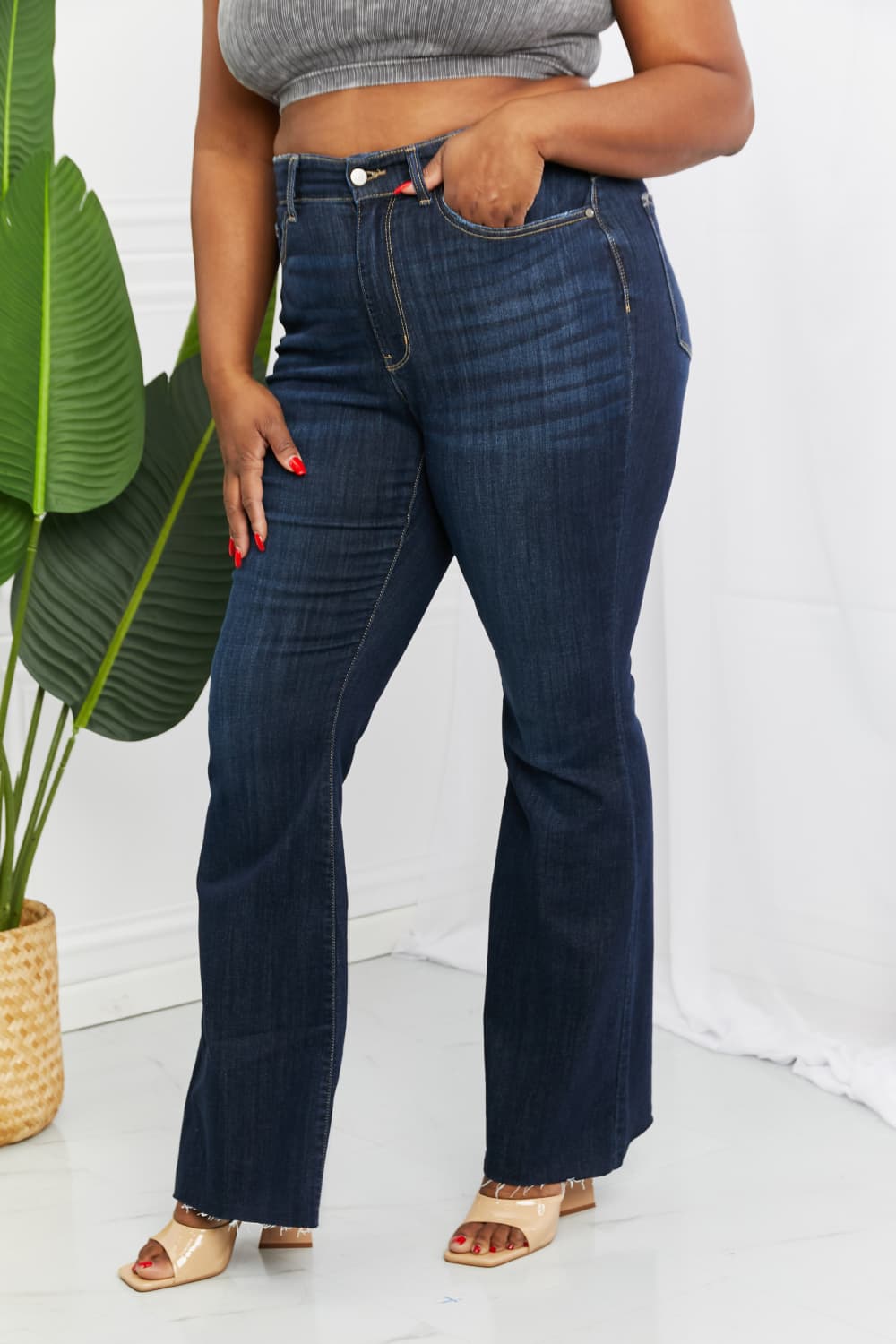 Judy Blue Tiffany Full Size Mid Rise Flare Jeans in dark wash, showcasing the flattering mid-rise waist and flare leg silhouette.