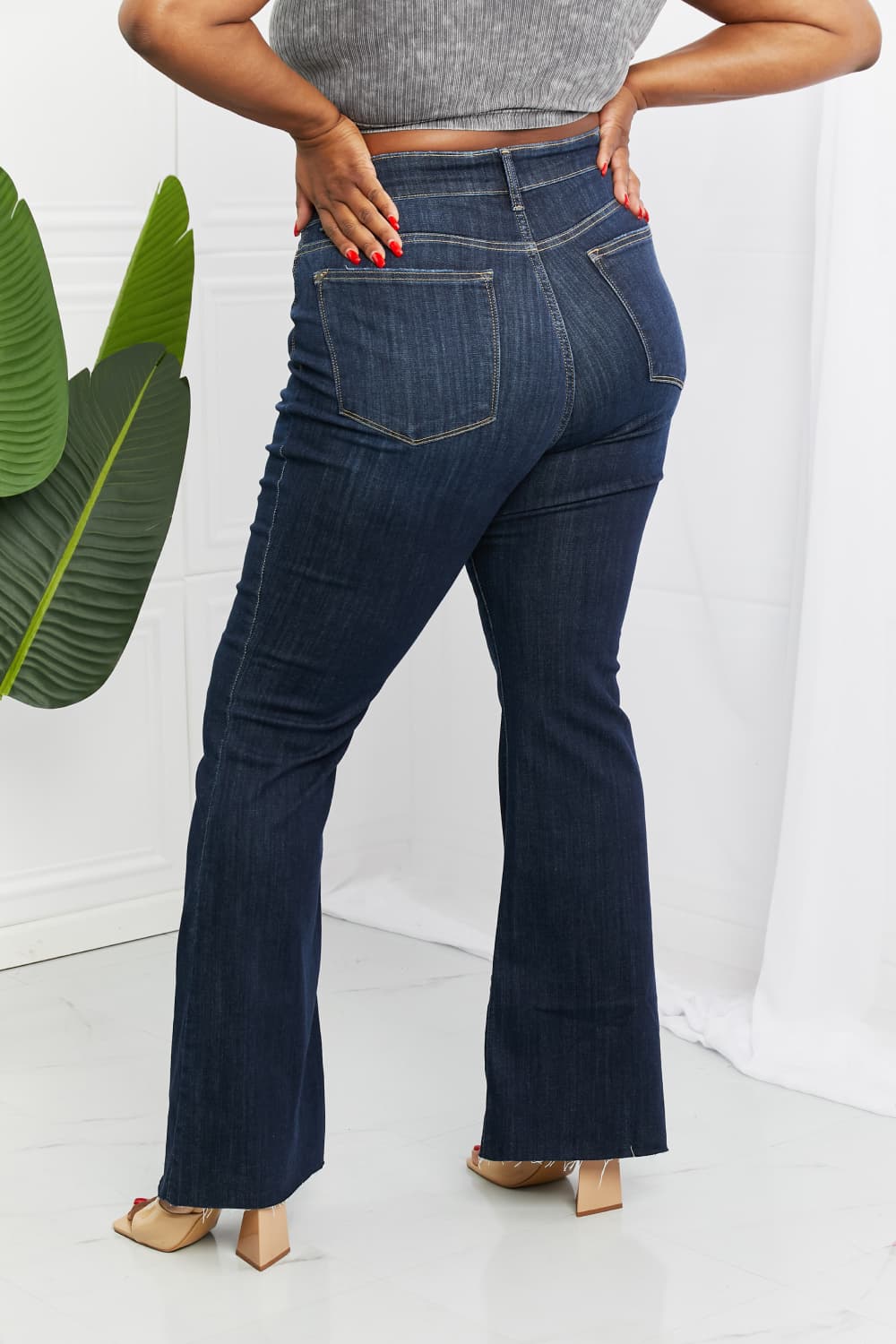 Judy Blue Tiffany Full Size Mid Rise Flare Jeans in dark wash, showcasing the flattering mid-rise waist and flare leg silhouette.