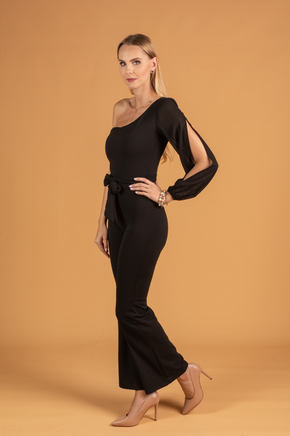 Elegant black jumpsuit with translucent sleeves and decorative belt, perfect for sophisticated occasions.