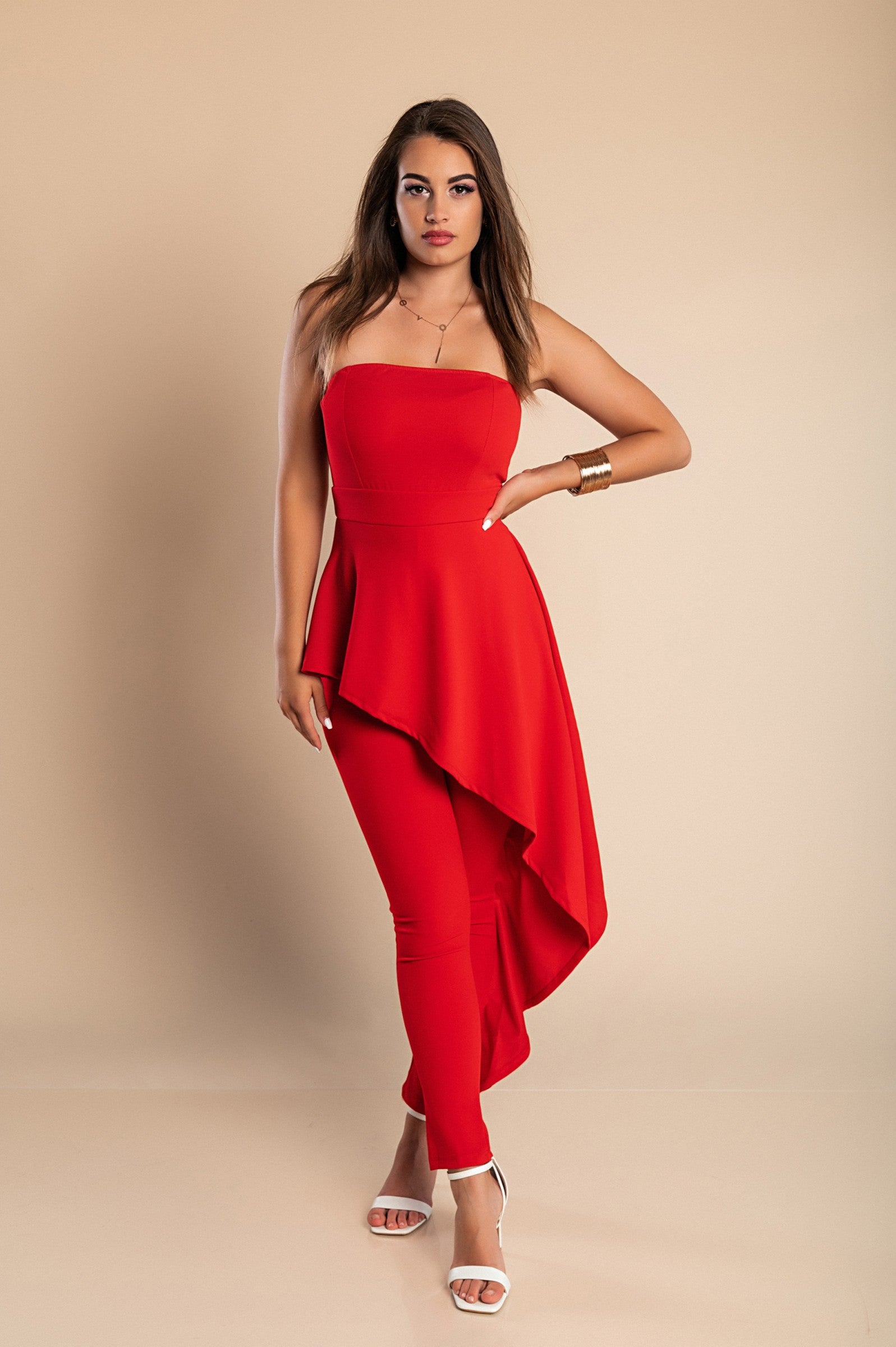 Elegant red jumpsuit with long tight pants and back zipper, featuring fashionable side fabrics, made in Italy.