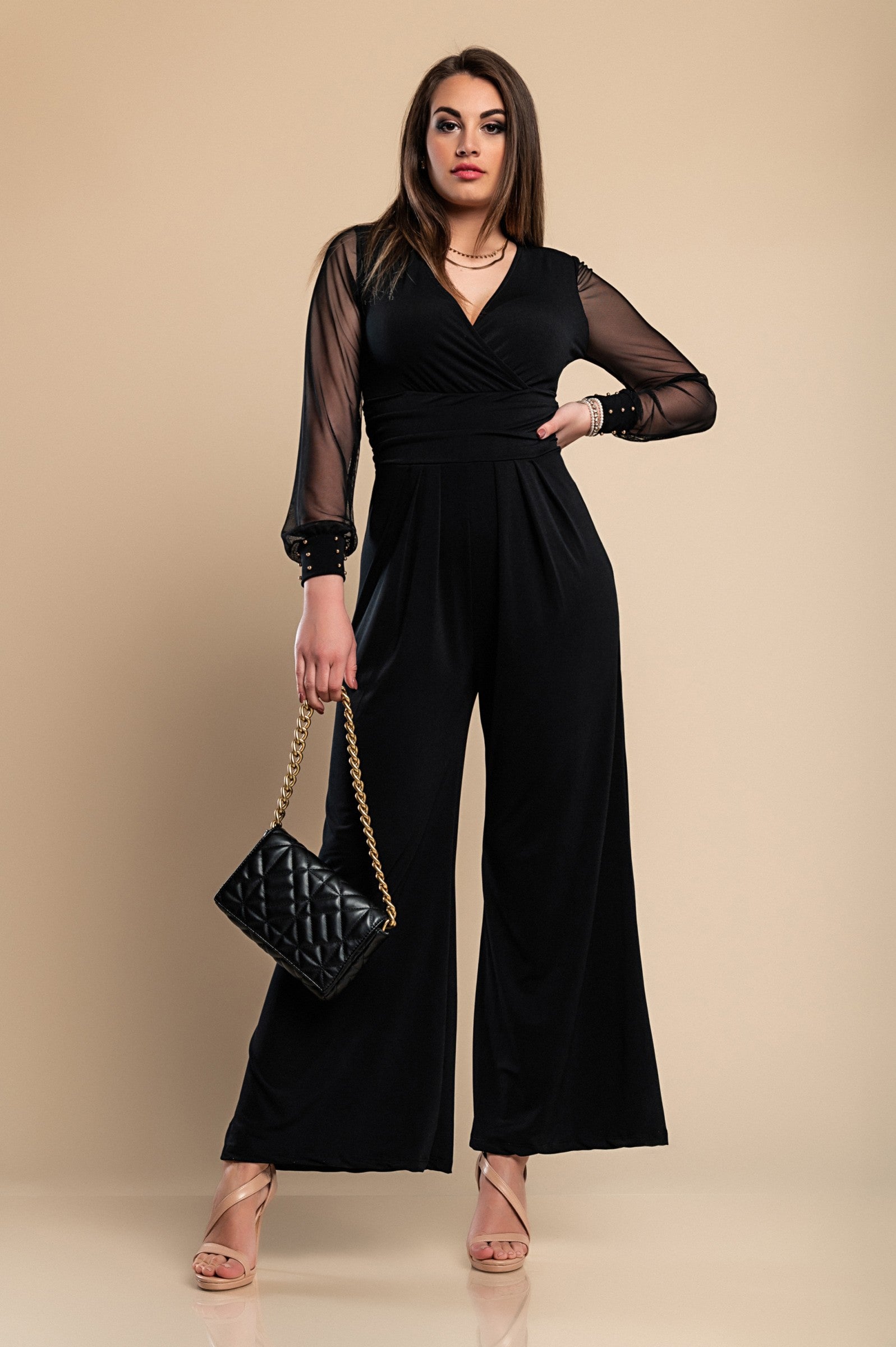 Elegant black jumpsuit with 'V' neckline and translucent long sleeves, featuring fashionable wrist accessories.