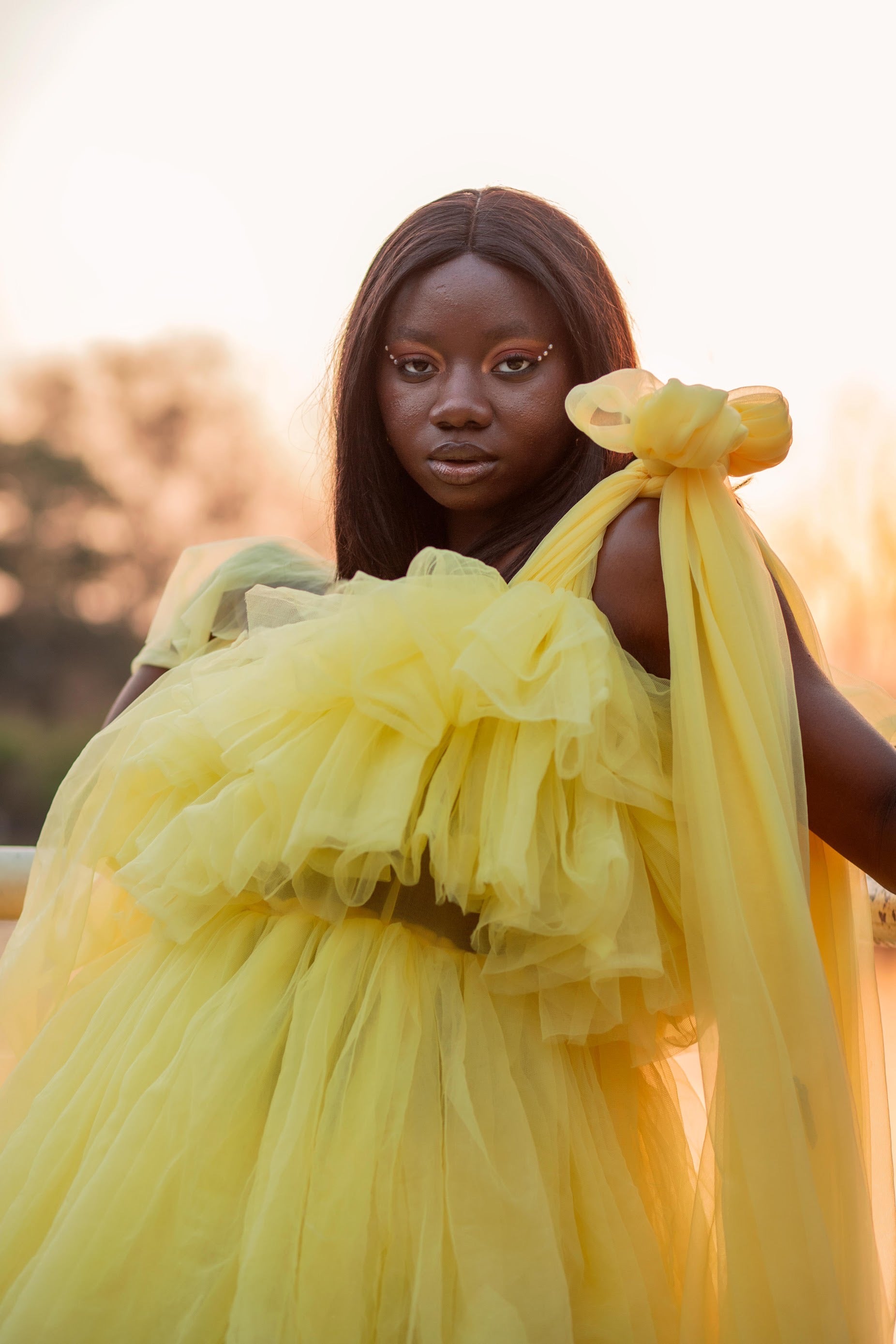 A stunning Kamila Dress made of tulle, showcasing its unique design and vibrant color options.